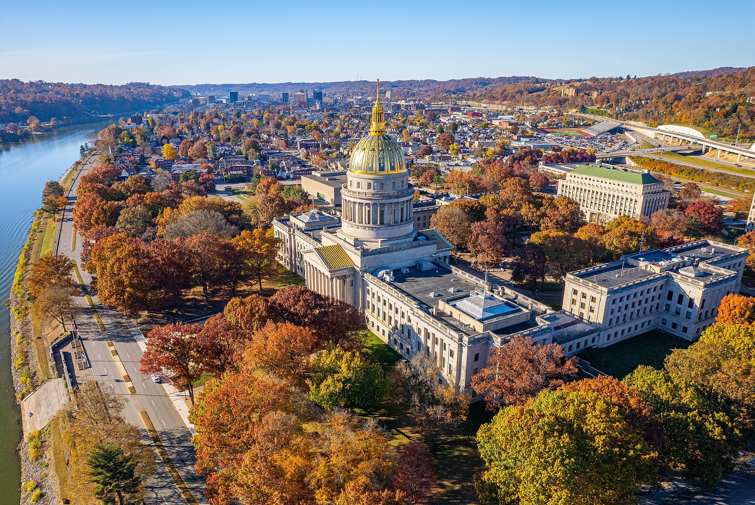 An aerial view of the West Virginia State Capitol Building and downtown Charleston with fall foliage.