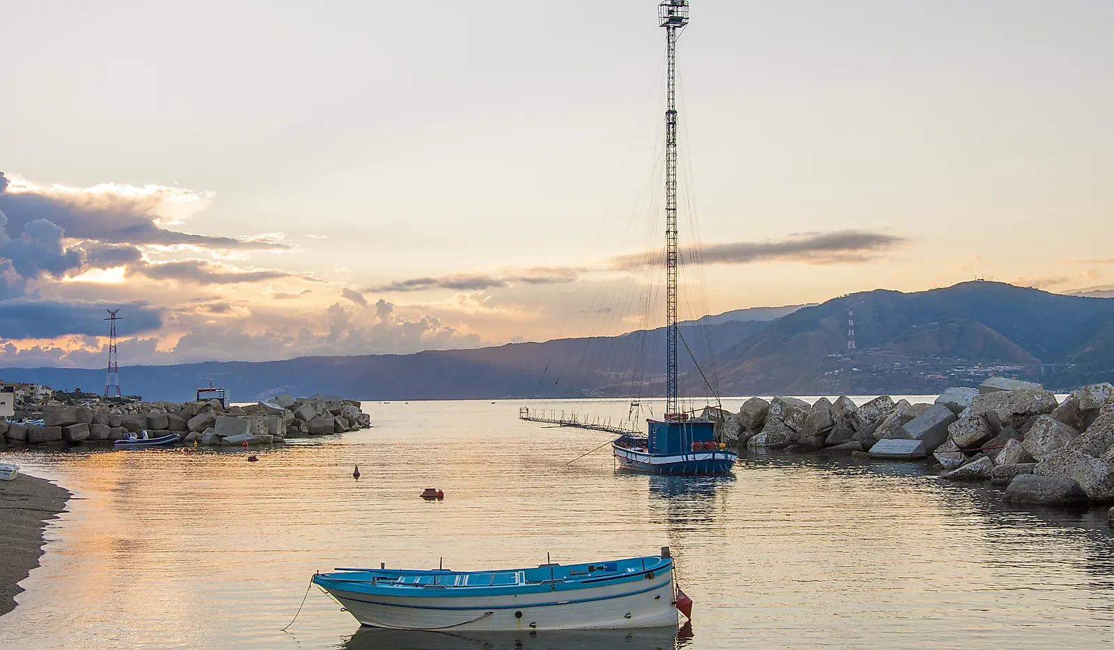 Feluca at dawn, the boats for swordfish hunting in the Strait of Messina, Sicily, Italy.