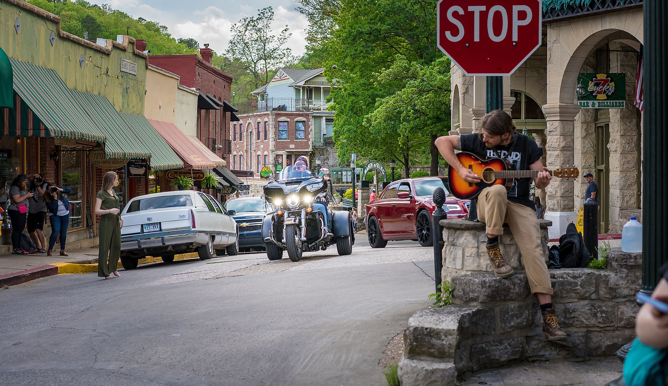  A man playing a guitar in the downtown area of Eureaka Springs, Arkansas. Editorial credit: shuttersv / Shutterstock.com