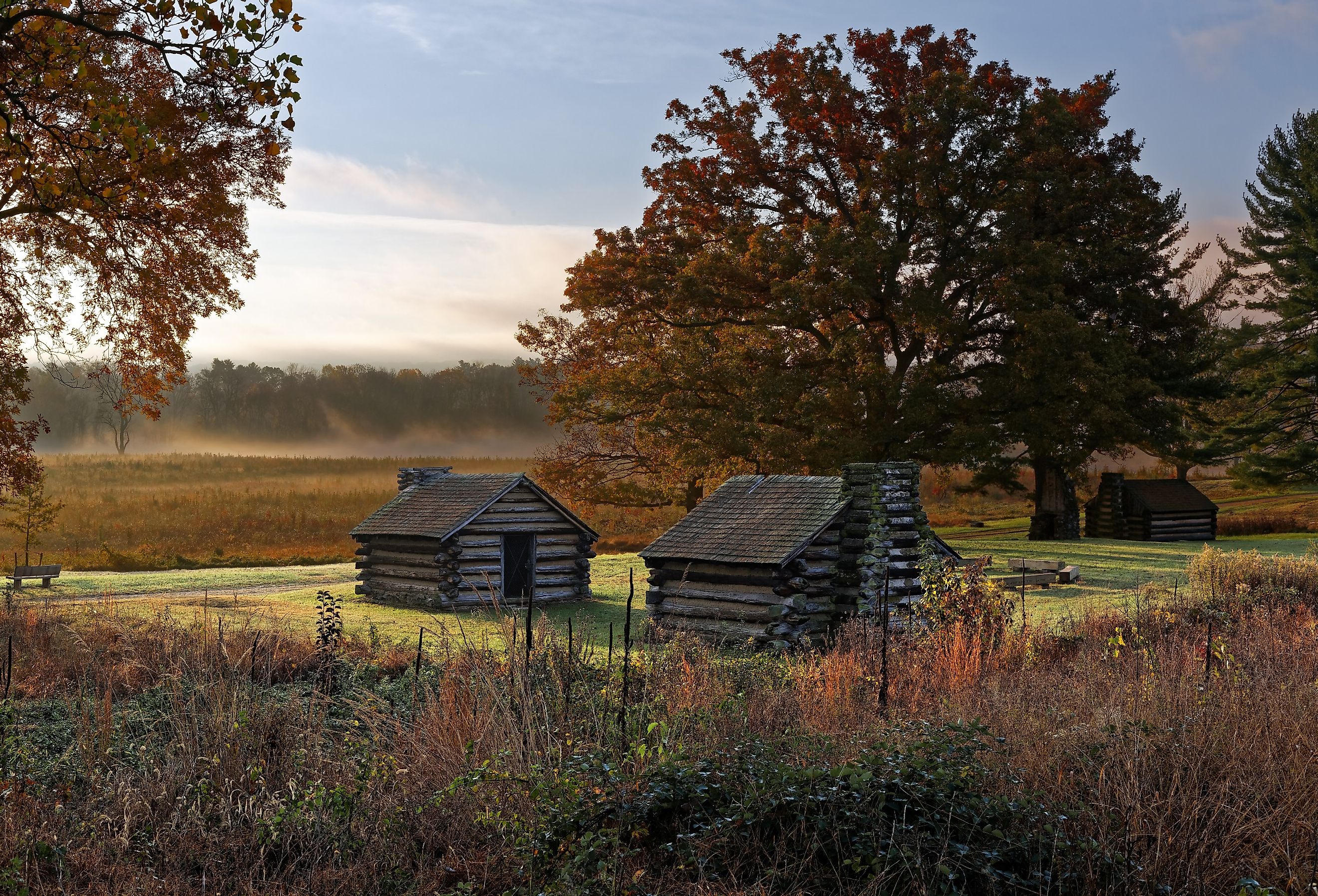Misty morning at Valley Forge National Historic Park with revolutionary log houses. Image credit Delmas Lehman via AdobeStock.