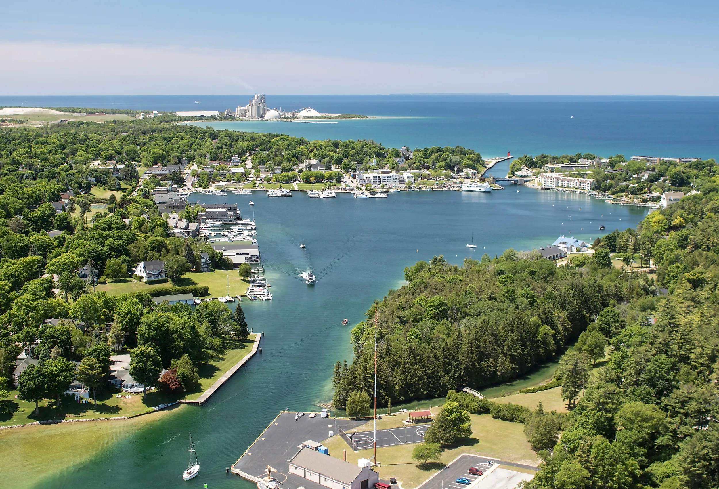 Aerial view of Round Lake in Charlevoix, Michigan, early summer, with boat traffic.