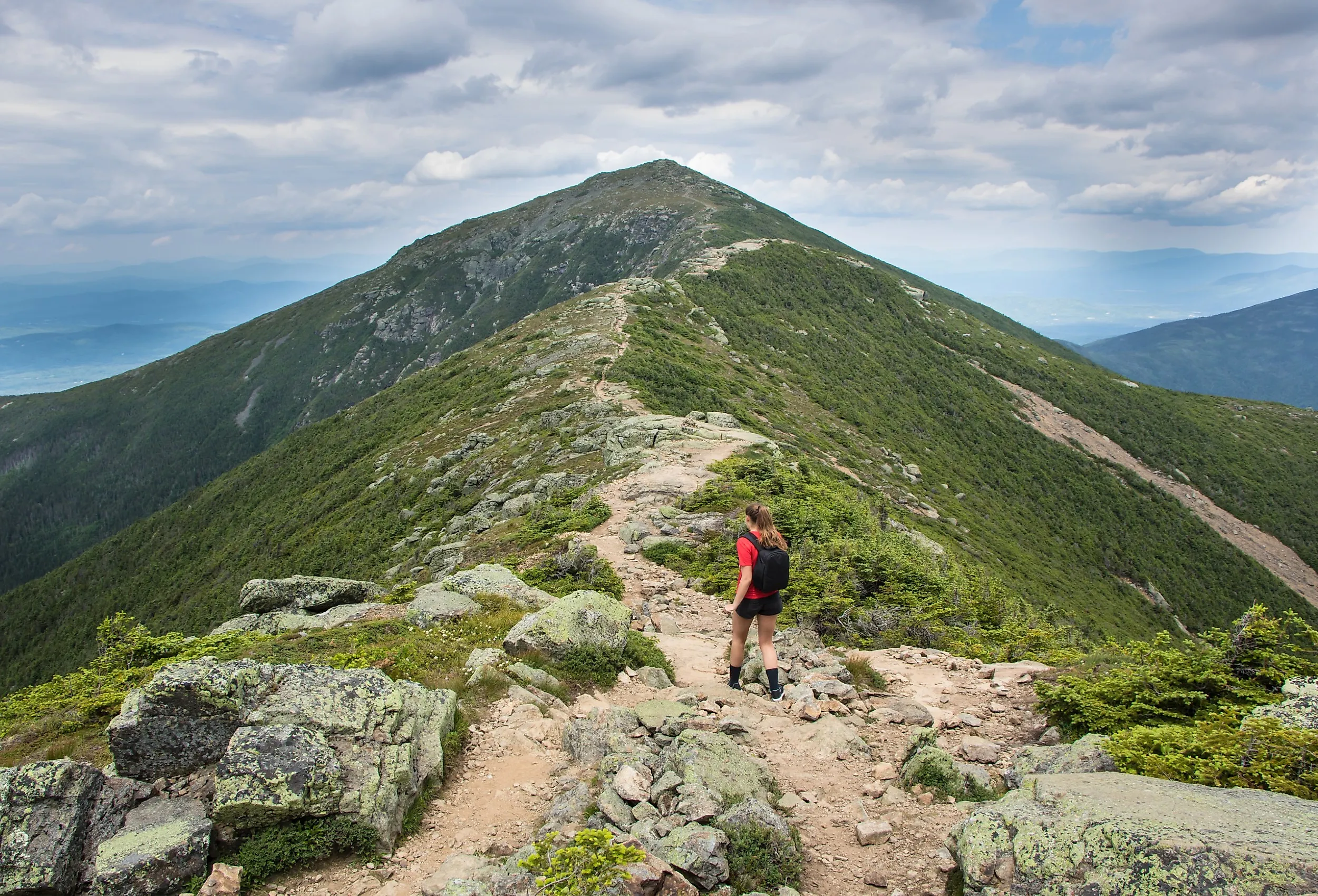 Young teenage girl walking on the Franconia Ridge Trail in New Hampshire’s White Mountains.