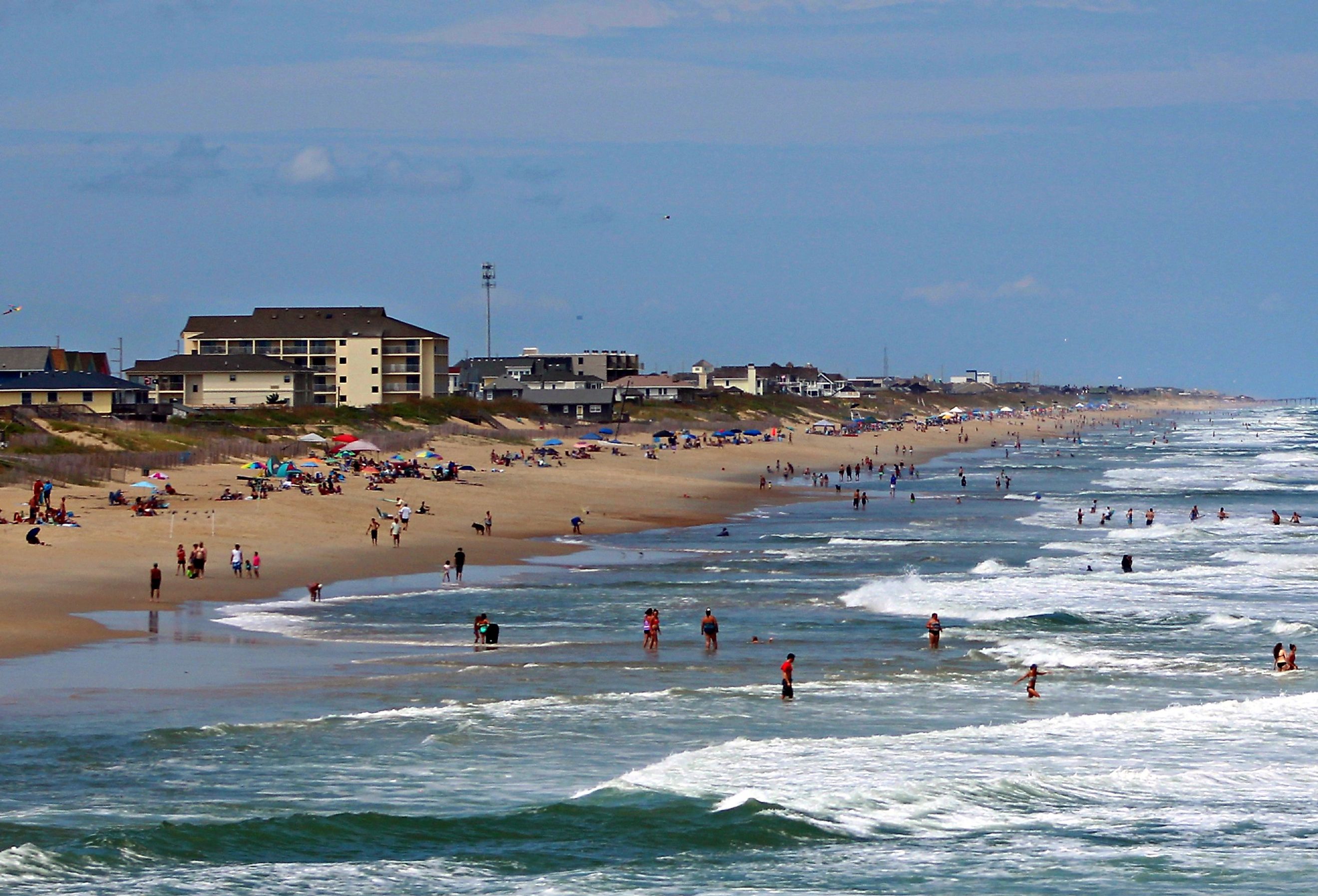 People on the beach and in the water at Nags Head Beach, Outer Banks.