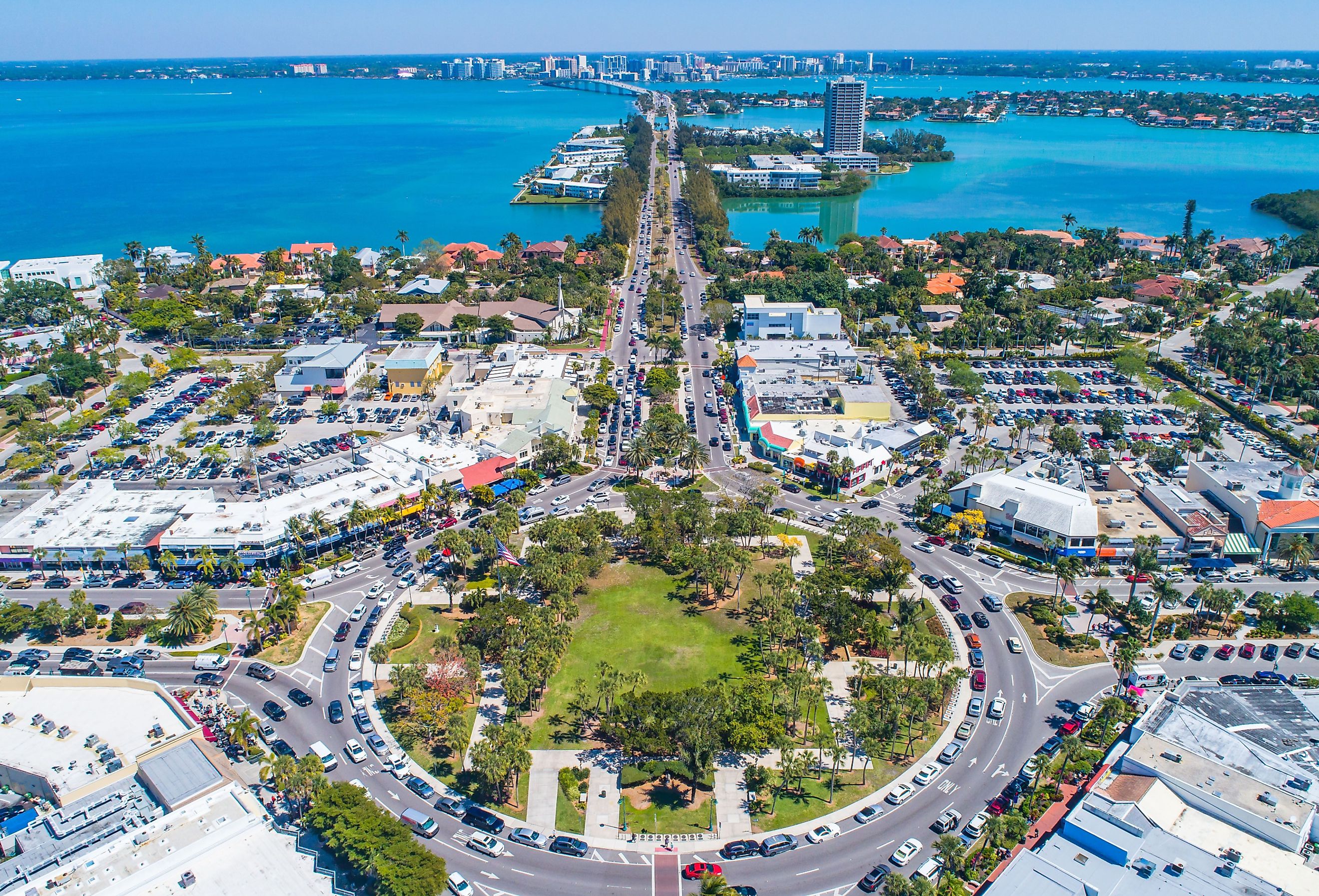 St Armands Circle in Sarasota, Florida. Drone image with sunny blue skies and crystal waters. Image credit Suncoast Aerials via Shutterstock.