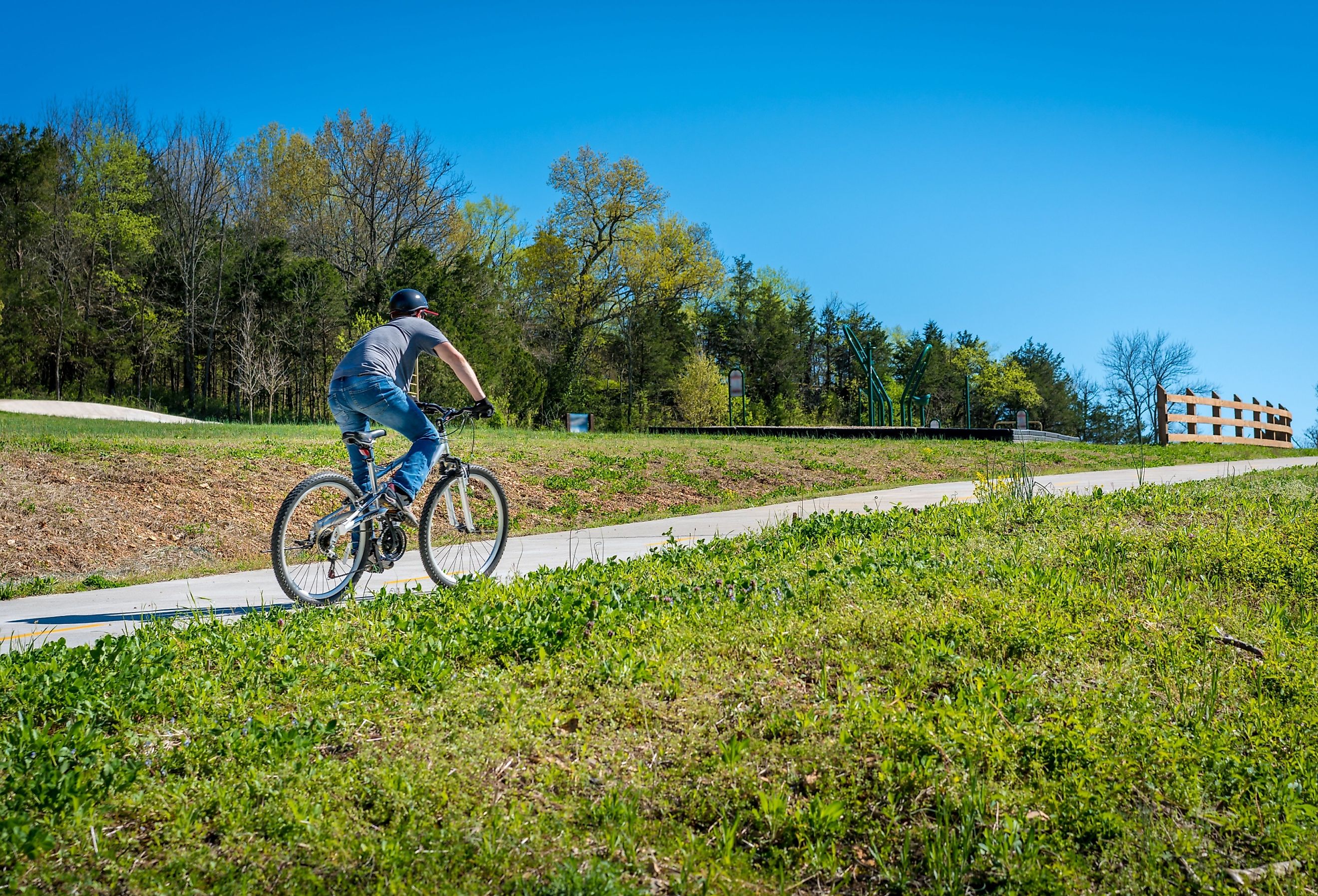 Young man biking on a trail in Bella Vista in Northwest Arkansas.