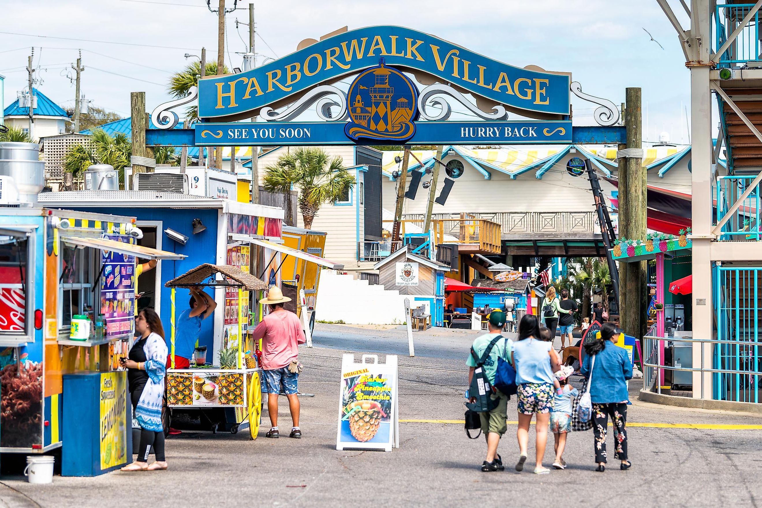 Destin, USA - April 24, 2018: Sign for Harborwalk Village in Emerald Grande Coast in Florida Panhandle with people walking and shopping,