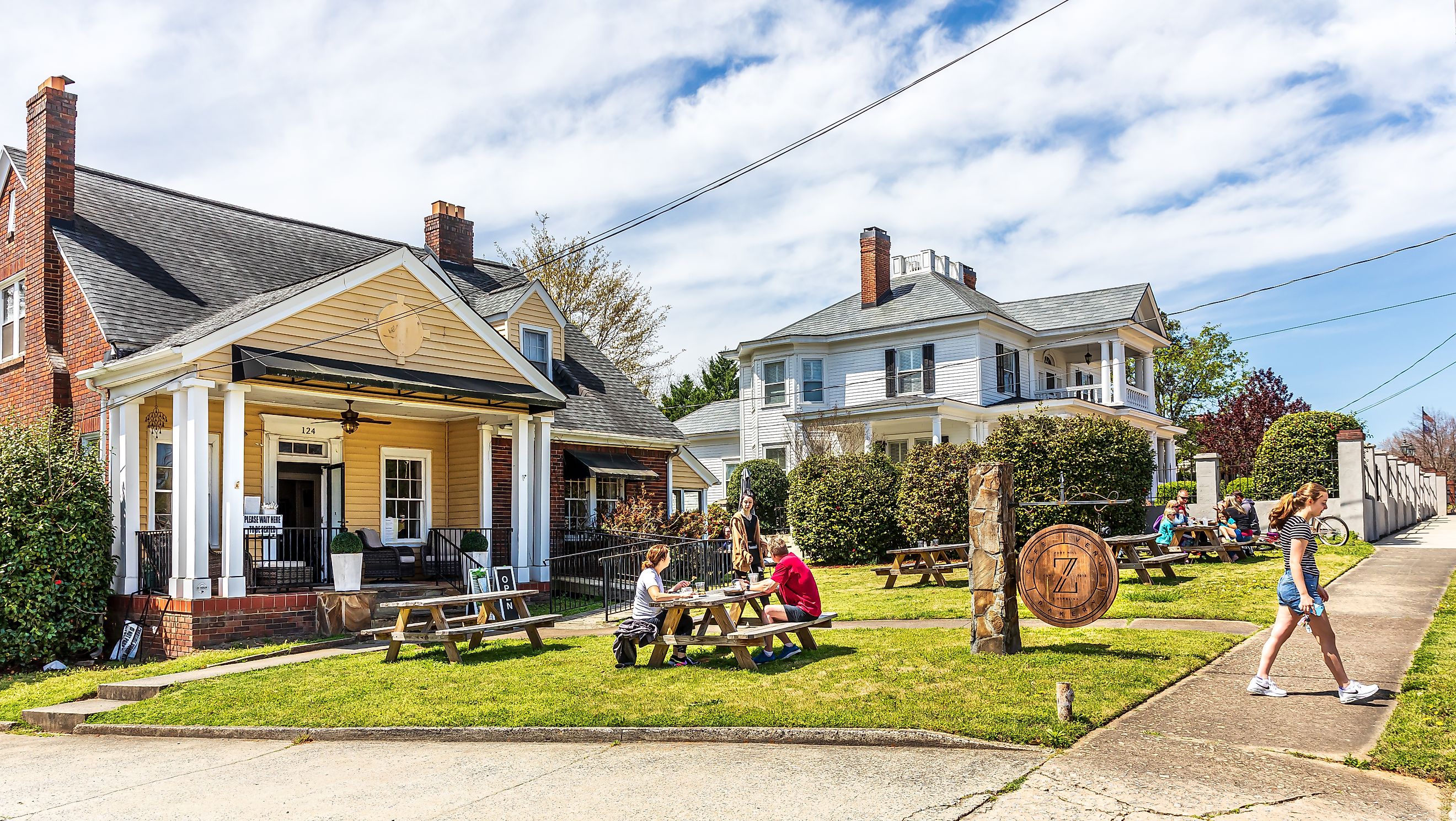  Bakery and Cafe in downtown fort mill south carolina, with multiple people eating outside on picnic tables.