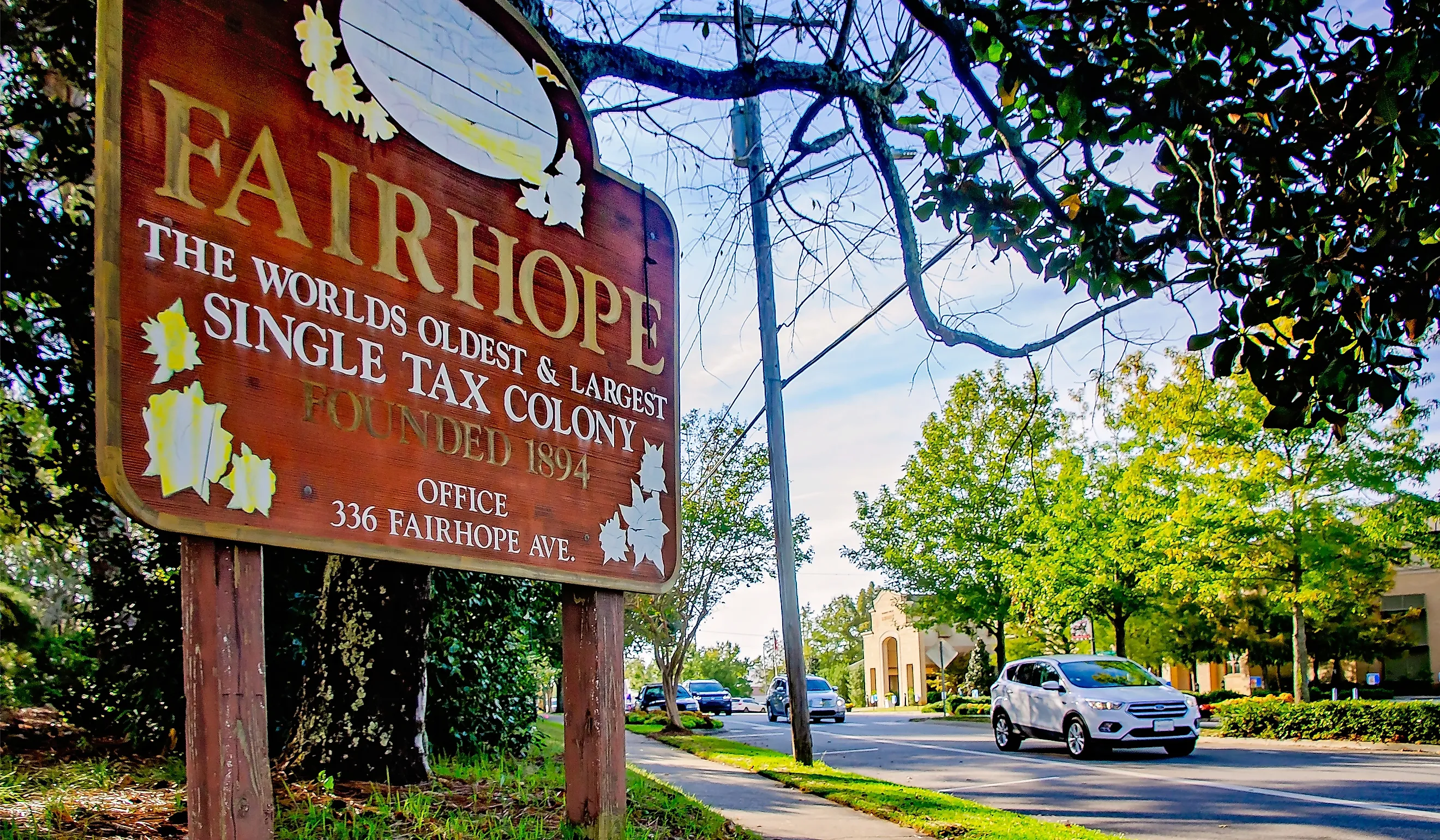 A sign welcomes visitors to Fairhope, Alabama, the worlds oldest and largest single tax colony. Image credit: Carmen K. Sisson / Shutterstock.com.