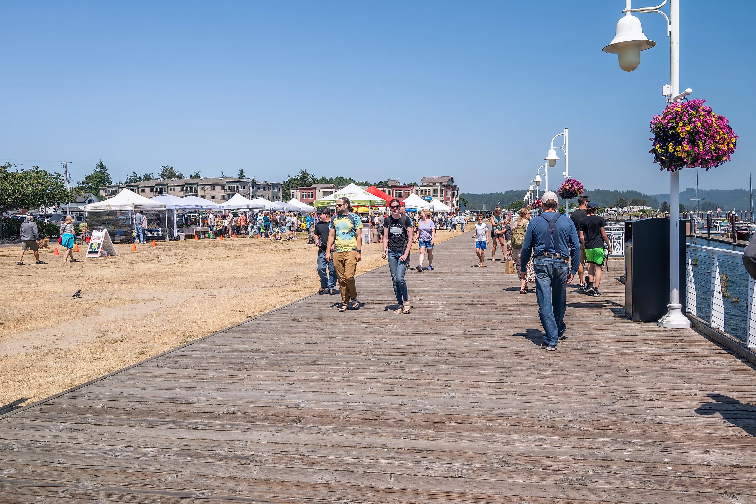 People along the boardwalk in Florence, Oregon. Image credit Manuela Durson via Shutterstock