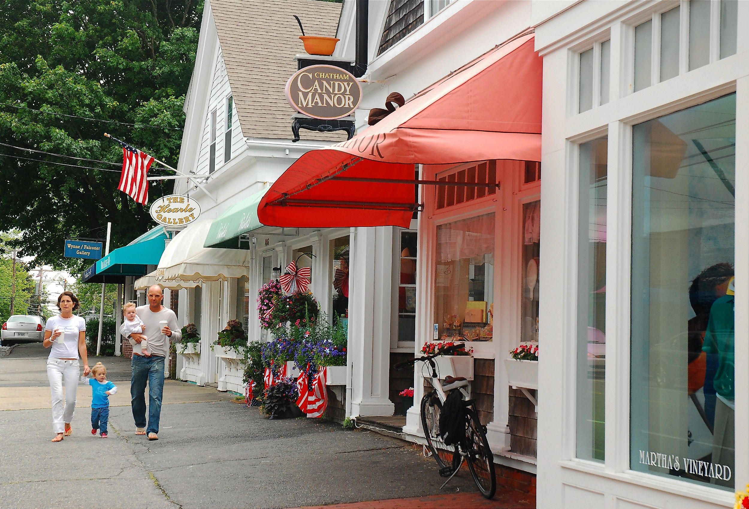 A young family walks through the charming Cape Cod town of Chatham, Massachusetts. Image credit James Kirkikis via Shutterstock