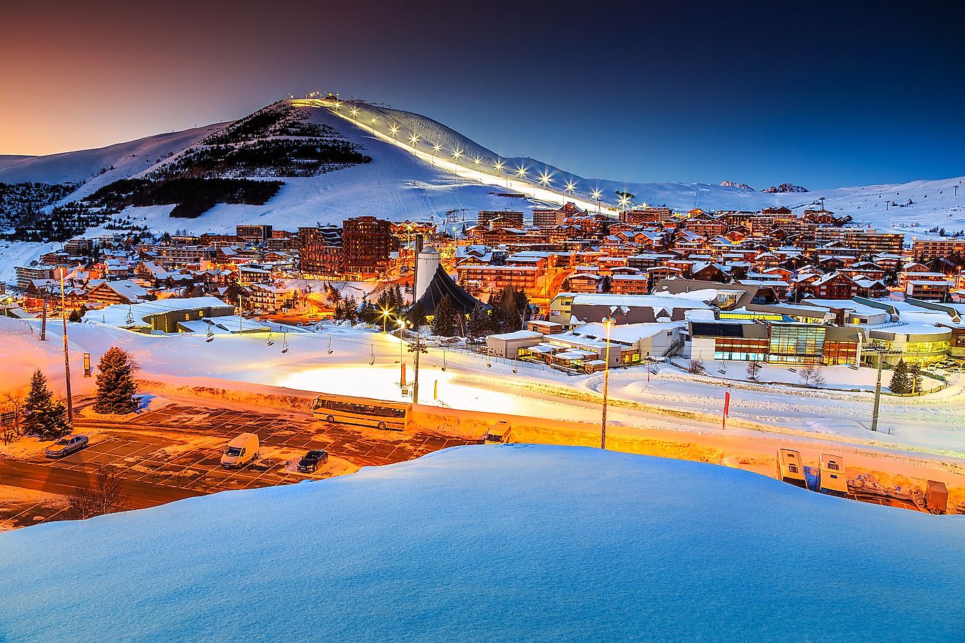 Stunning winter sunset landscape and ski resort with typical alpine wooden houses in French Alps,Alpe D Huez,France,Europe. Image credit: Gaspar Janos/Shutterstock.com