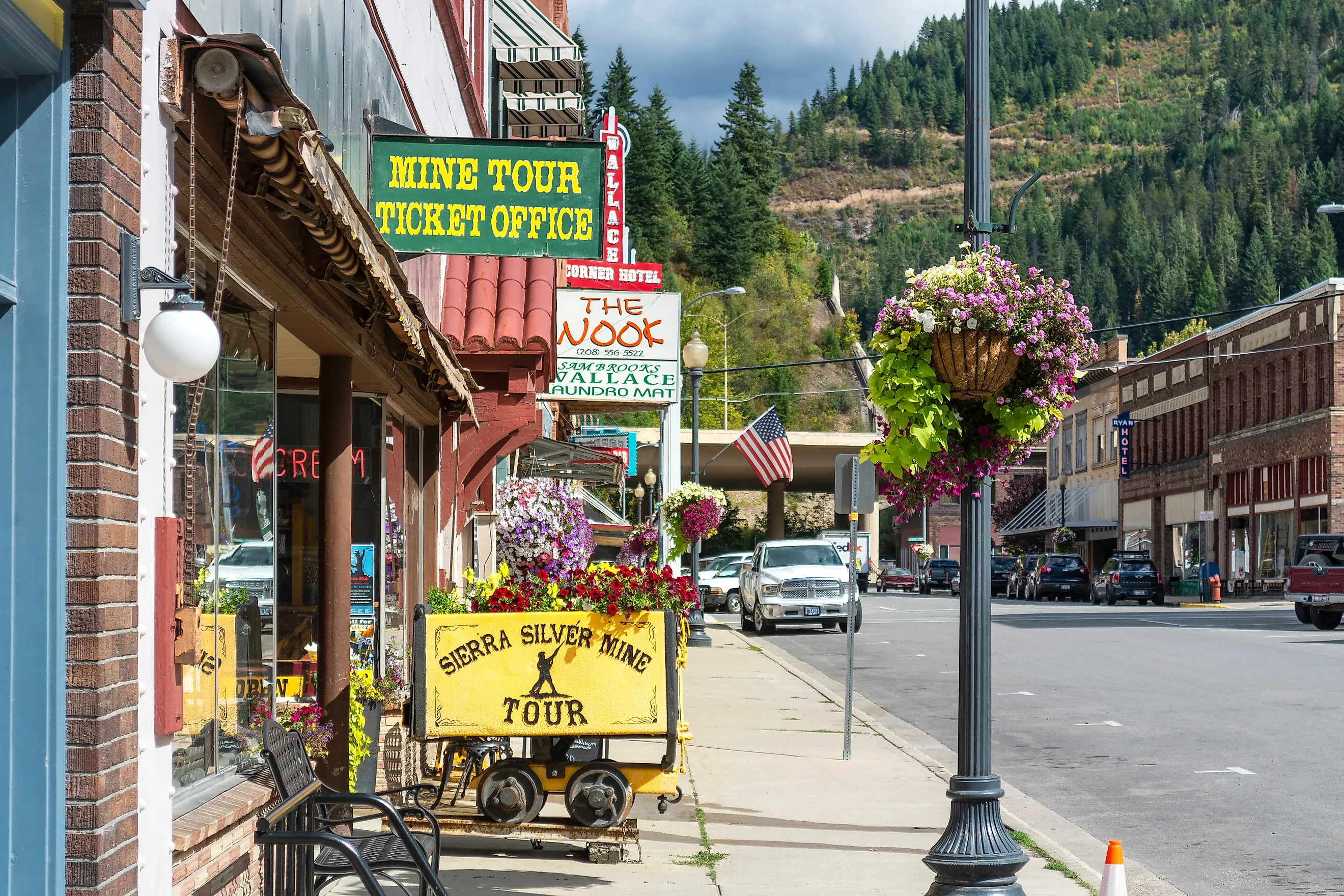General view of the Sierra Silver Mine tour sign on a sidewalk in the historic mountain town of Wallace, Idaho.