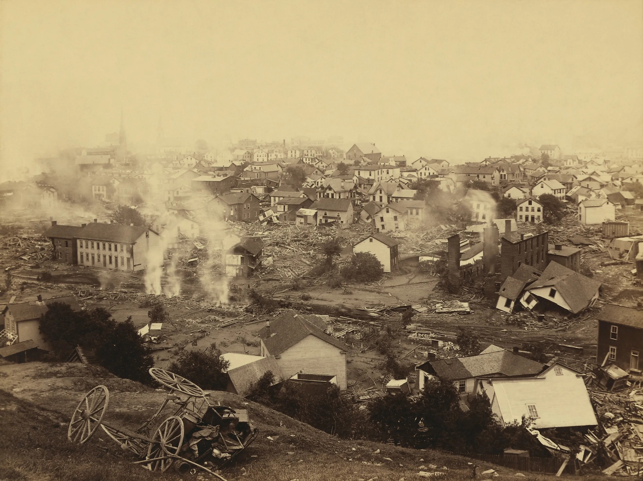 General view of Johnstown from high ground after the flood of May 31st, 1889. Horse drawn wagons and men work in the central mid-ground, possibly recovering bodies Editorial credit: Everett Collection / Shutterstock.com 