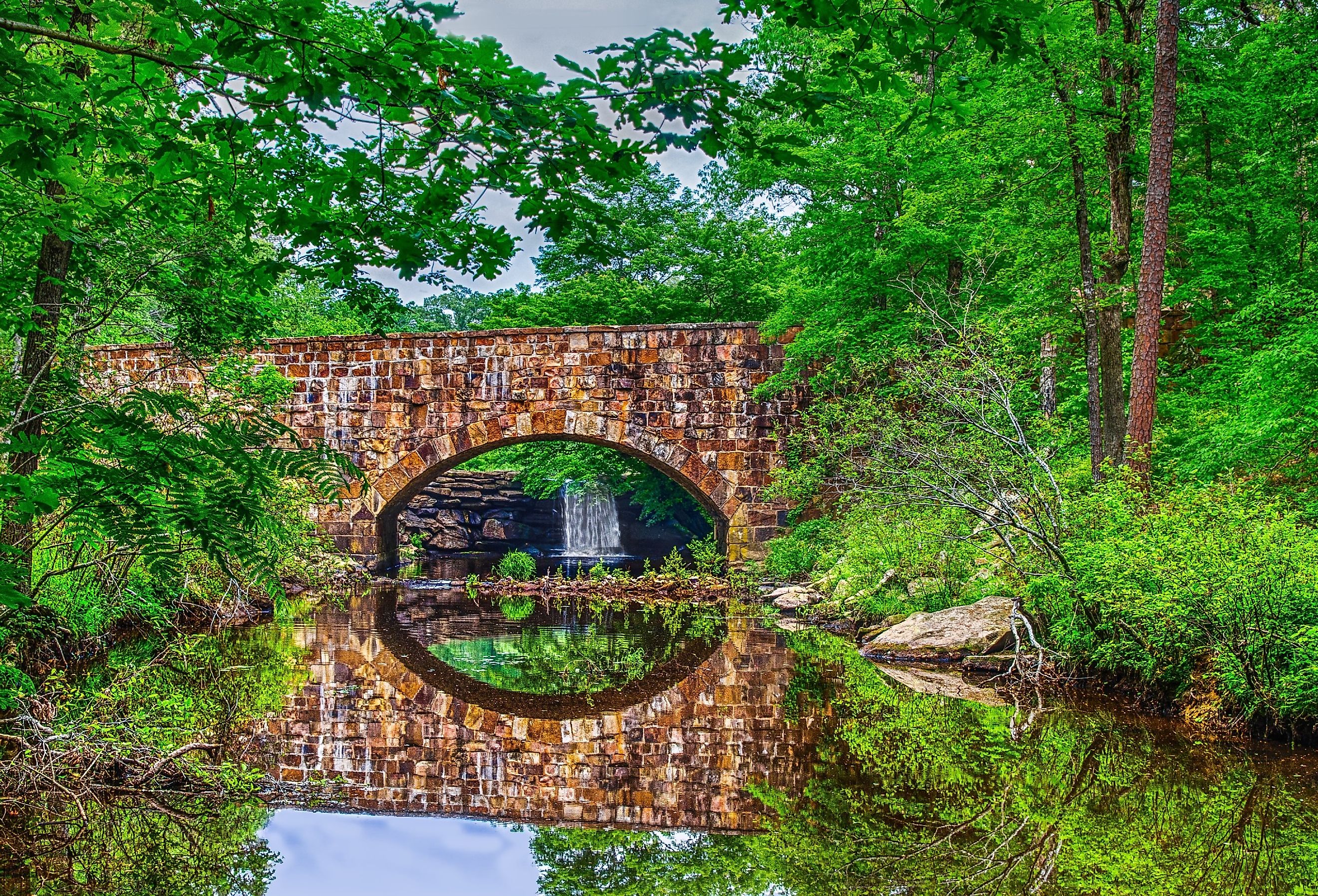 Foliage reflections of scenic Davies Bridge in Petit Jean State Park near Russellville, Arkansas.