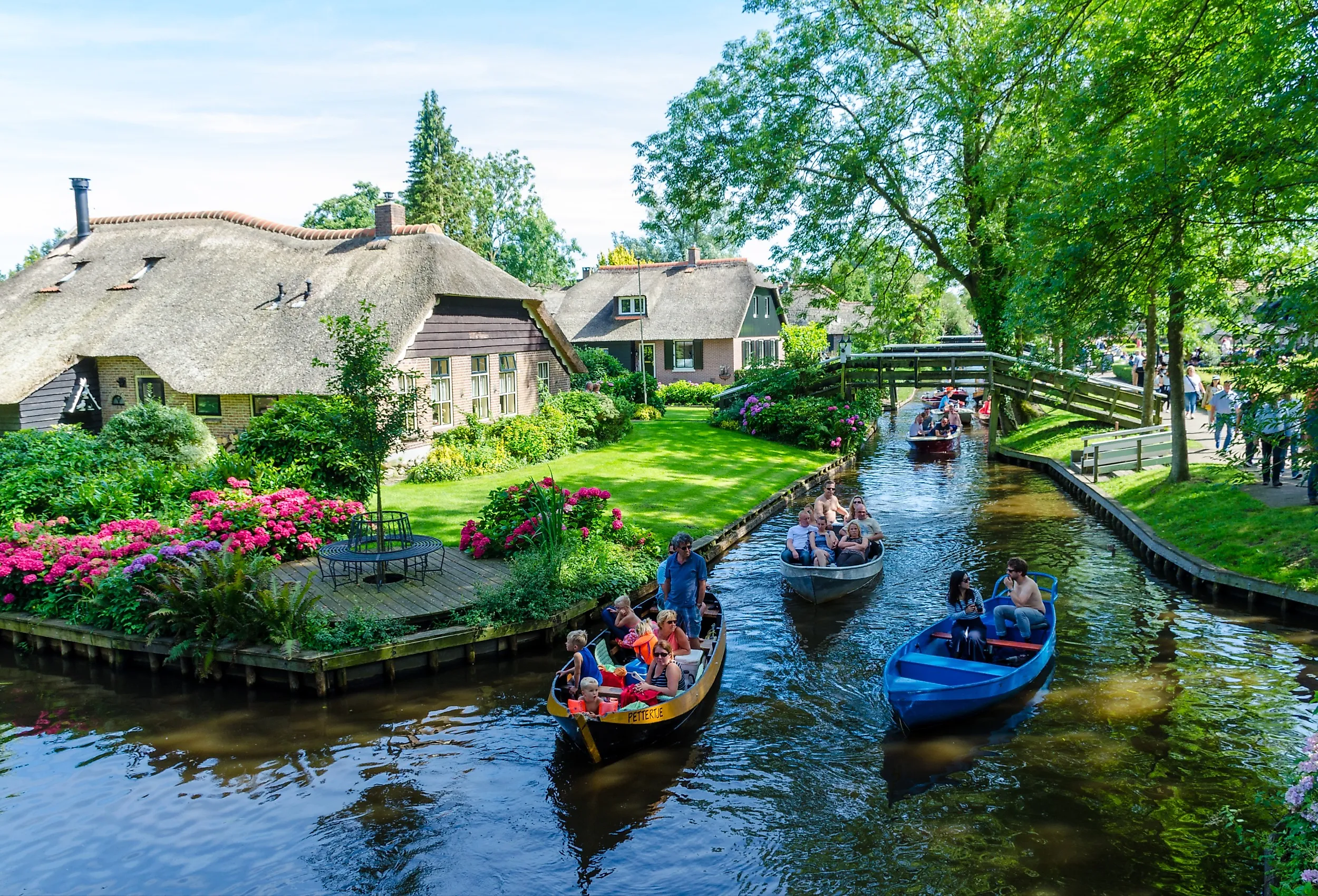 Folks cruising on the canals in Giethoorn, Netherlands. Editorial credit: rob3rt82 / Shutterstock.com