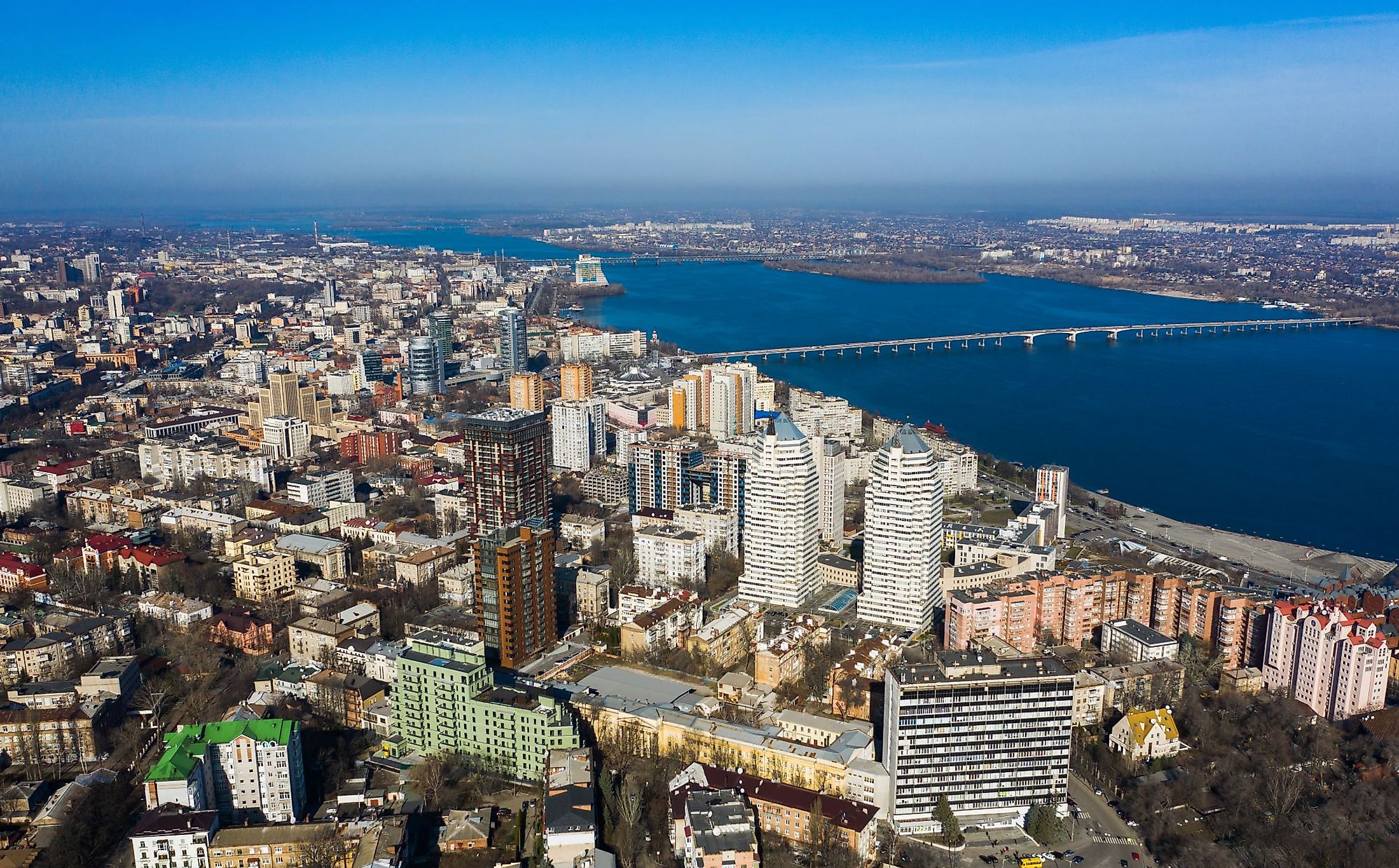 Aerial view of Dnipro city with the Dnieper River and different building blocks. 