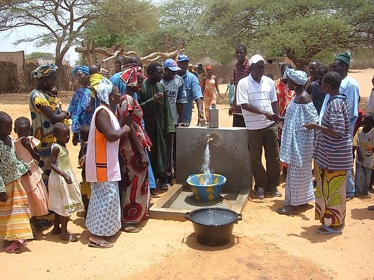Workers from the United Nations Development Program assisting well installation efforts in Gambia.
