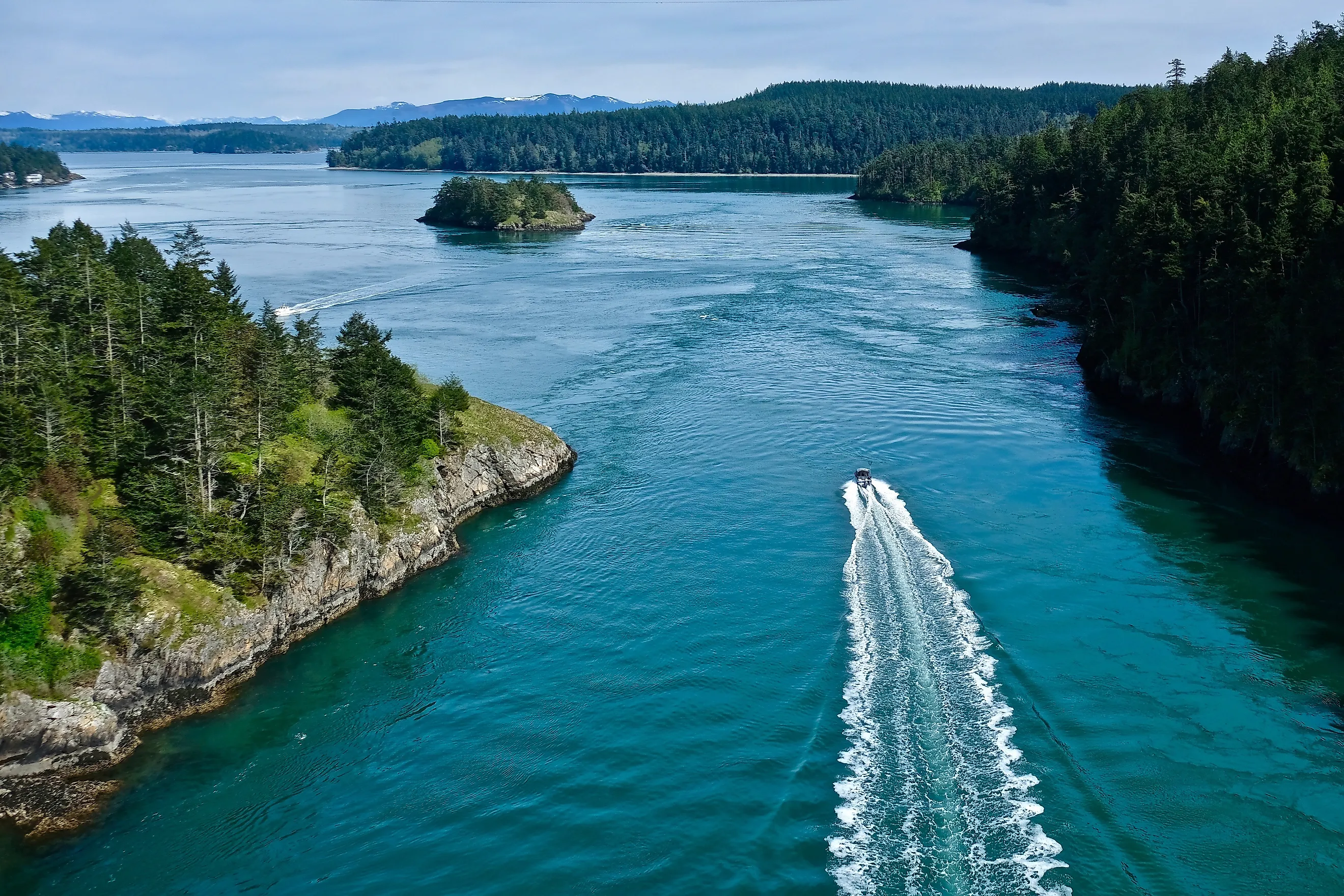 Boat in the ocean among islands. Deception Pass State Park near Anacortes WA.