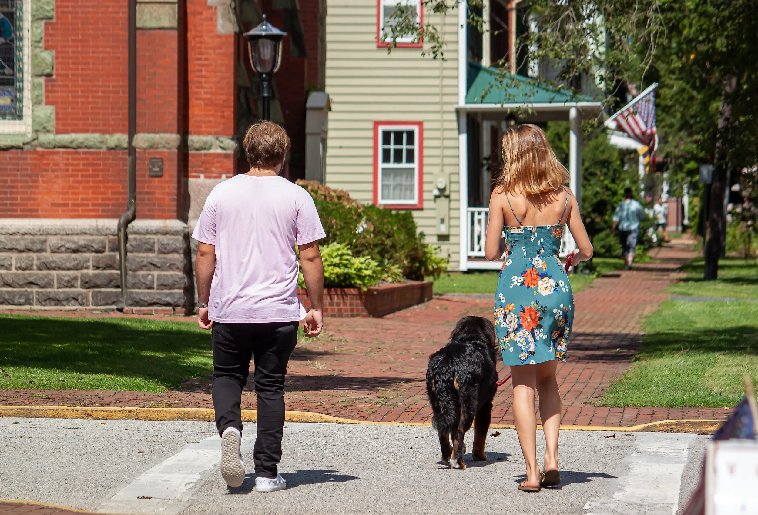 Two people and their dog walking in Chestertown. 