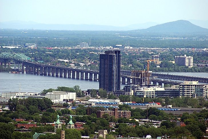The Saint Lawrence River passing under a bridge in the city of Montreal, Quebec, Canada.