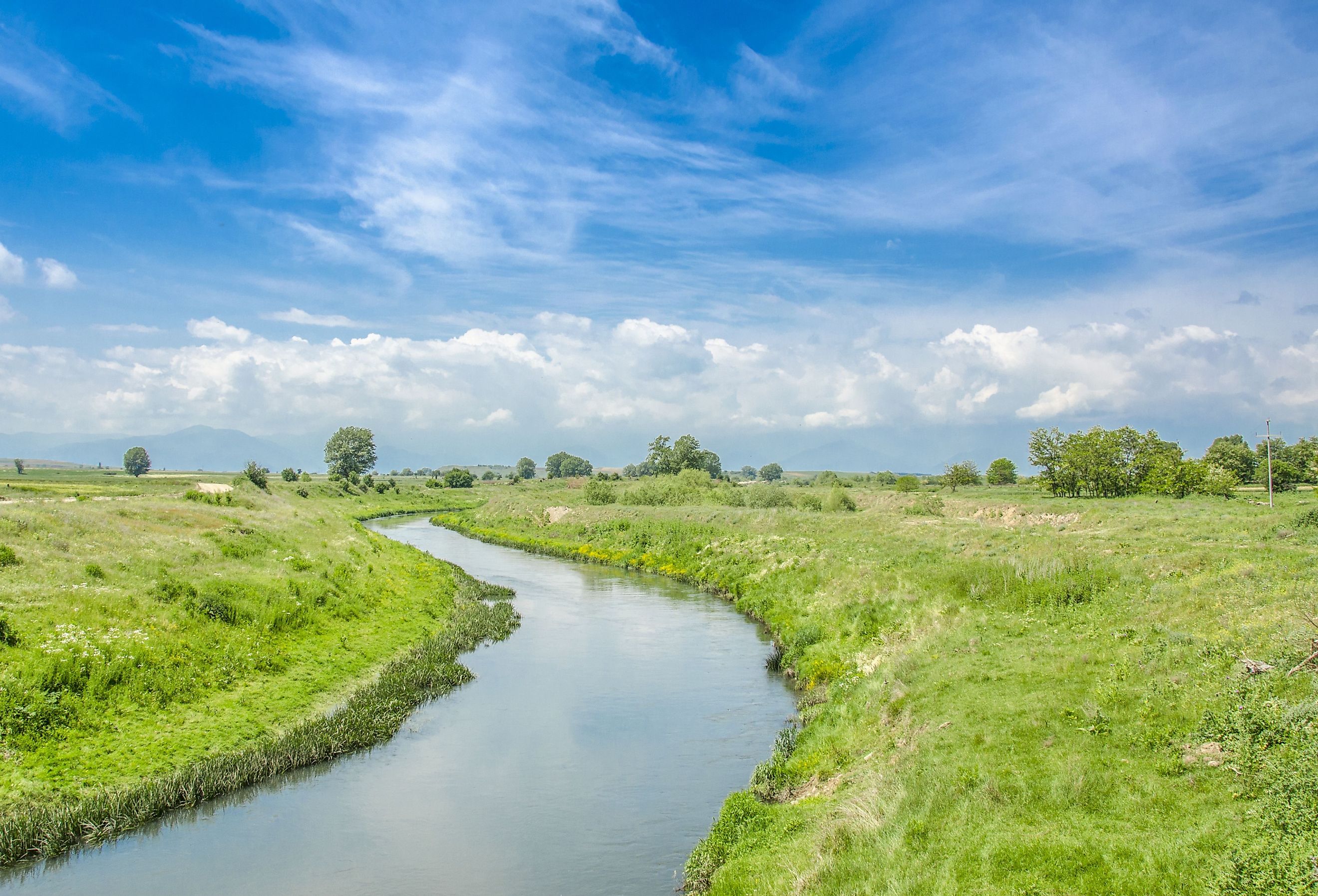 Crna River weaves through grass in North Macedona. Image credit Pargovski Jove via Shutterstock. 