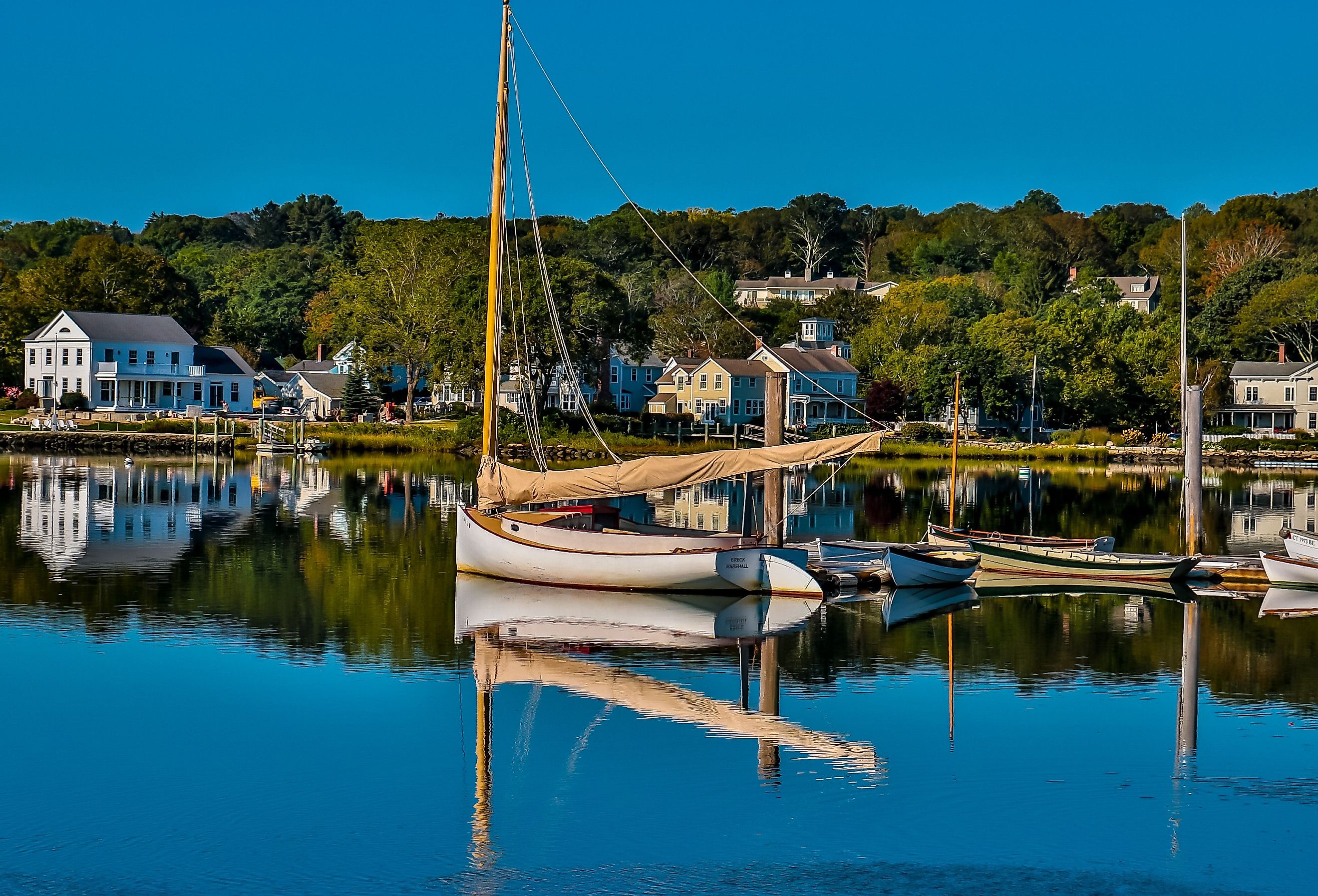 Boats in the Harbor and homes along the water in Mystic Seaport, Connecticut.