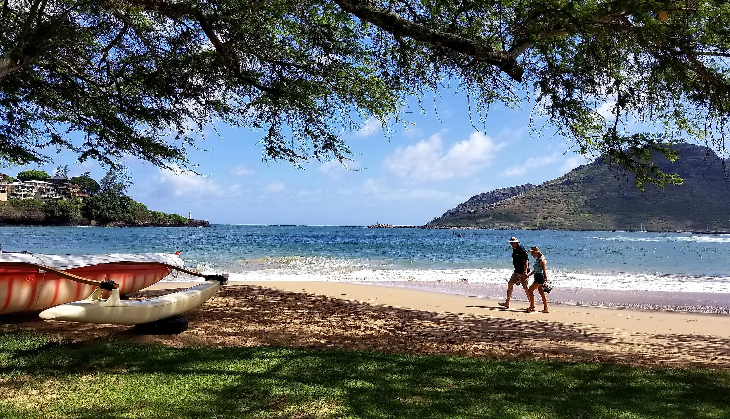 A couple walks along Kalapaki Beach in Lihue, Kaua'i, Hawai'i