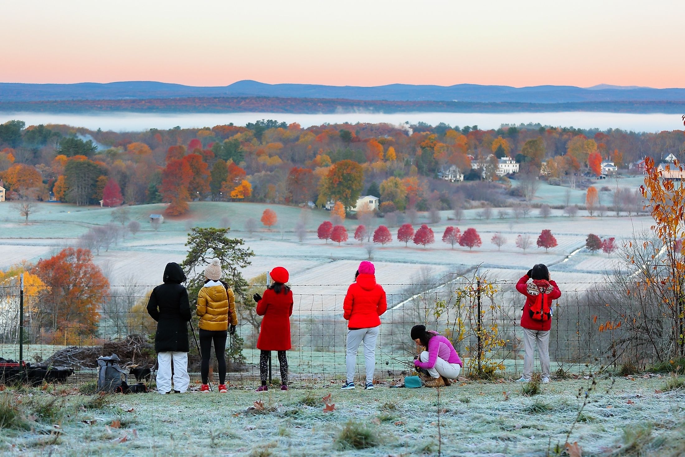 A group of tourists watching the sunrise at Bancroft's Castle View Point at Groton, Massachusetts.
