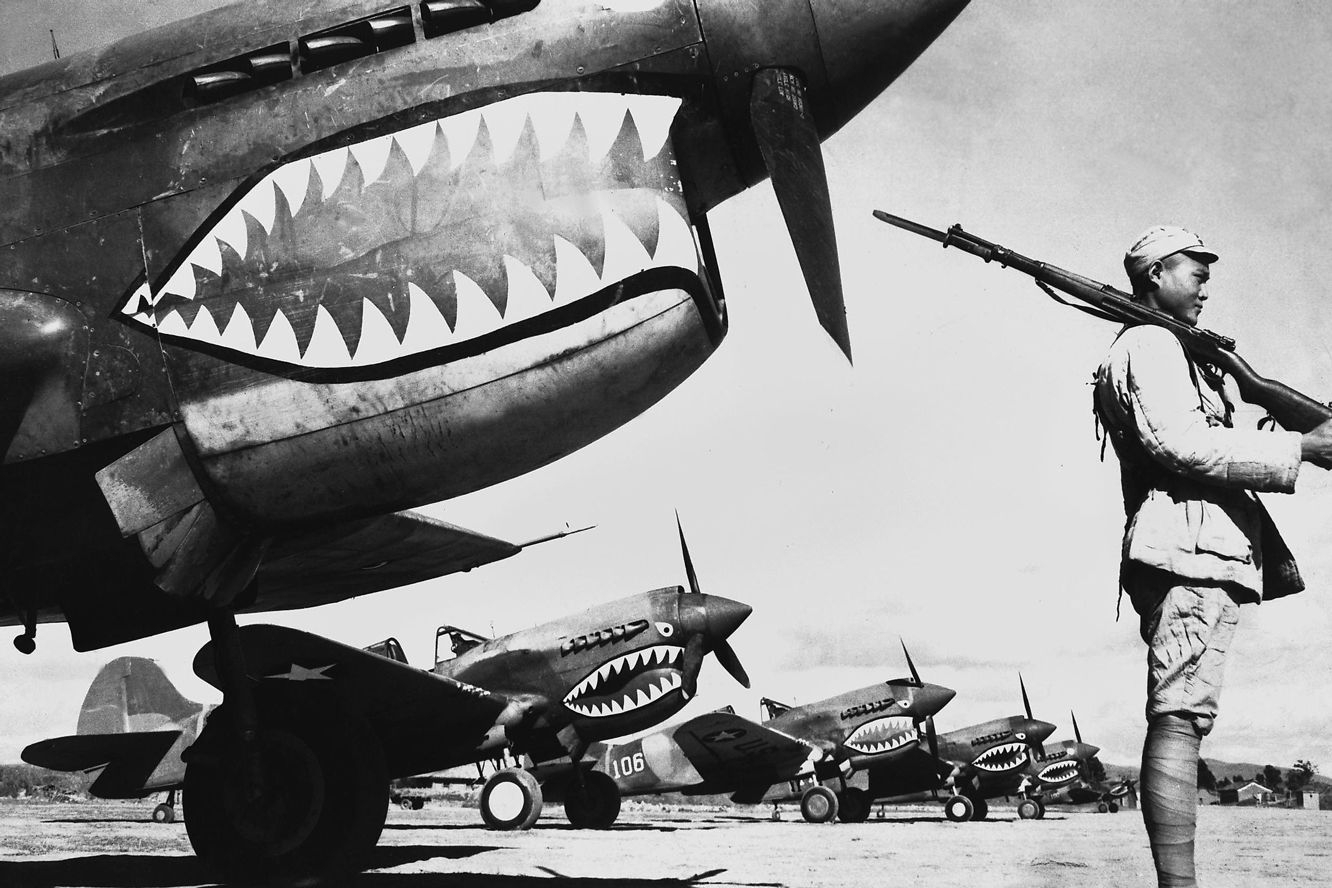 Chinese soldier guards a line of American P-40 fighter planes