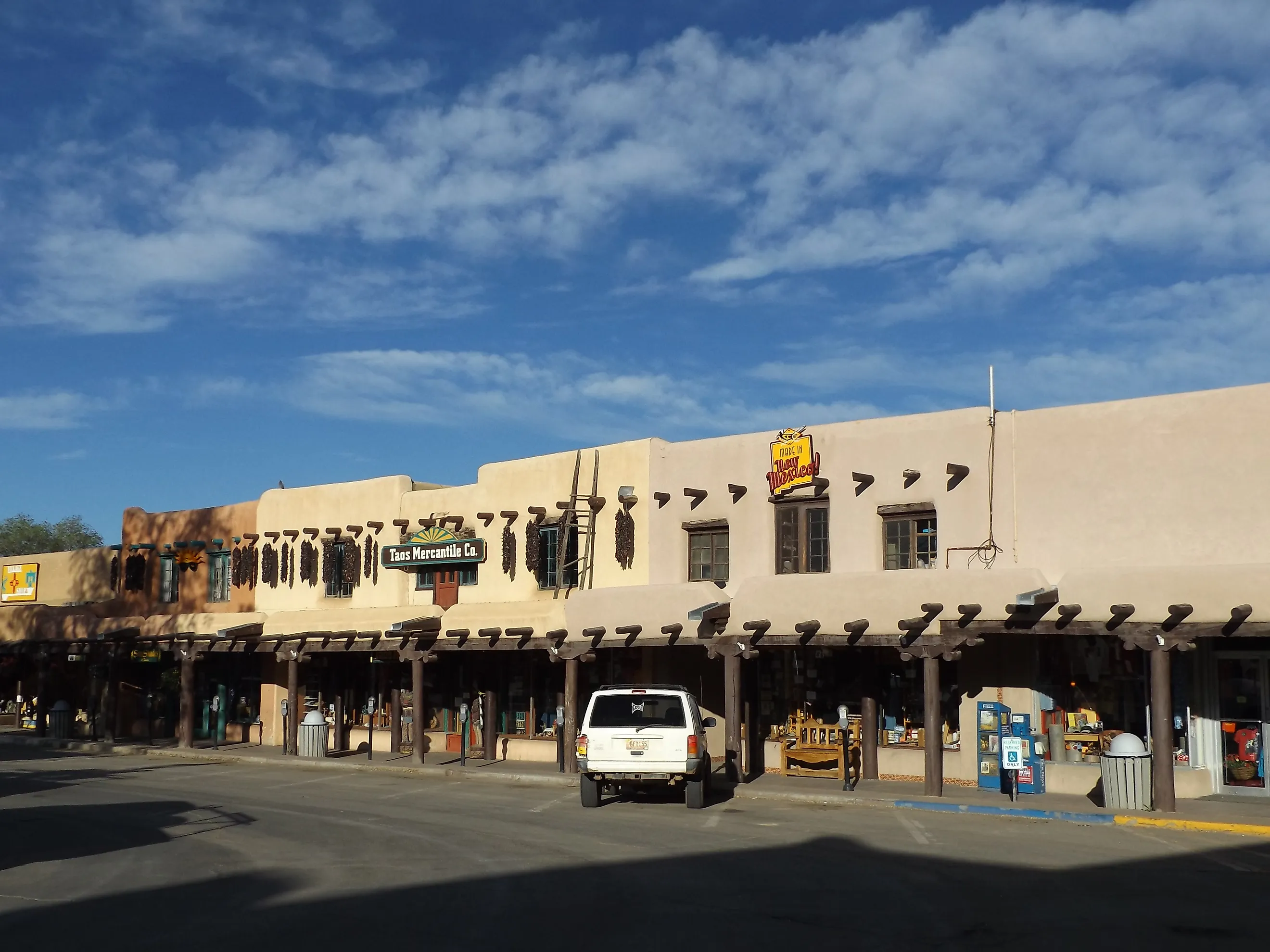 Street view of adobe storefronts in Taos, New Mexico.