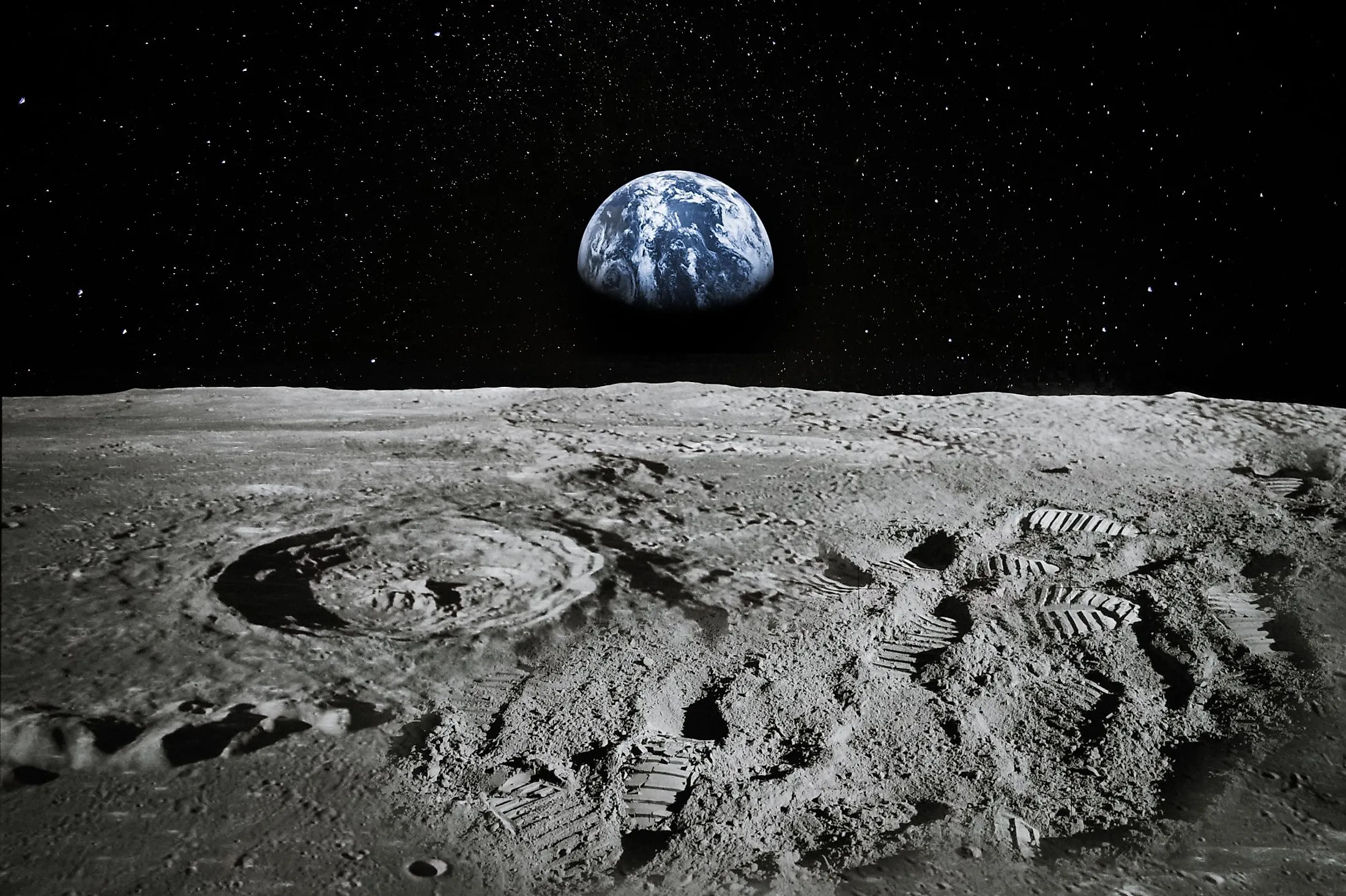 View of Moon surface with Earth rising on the horizon.