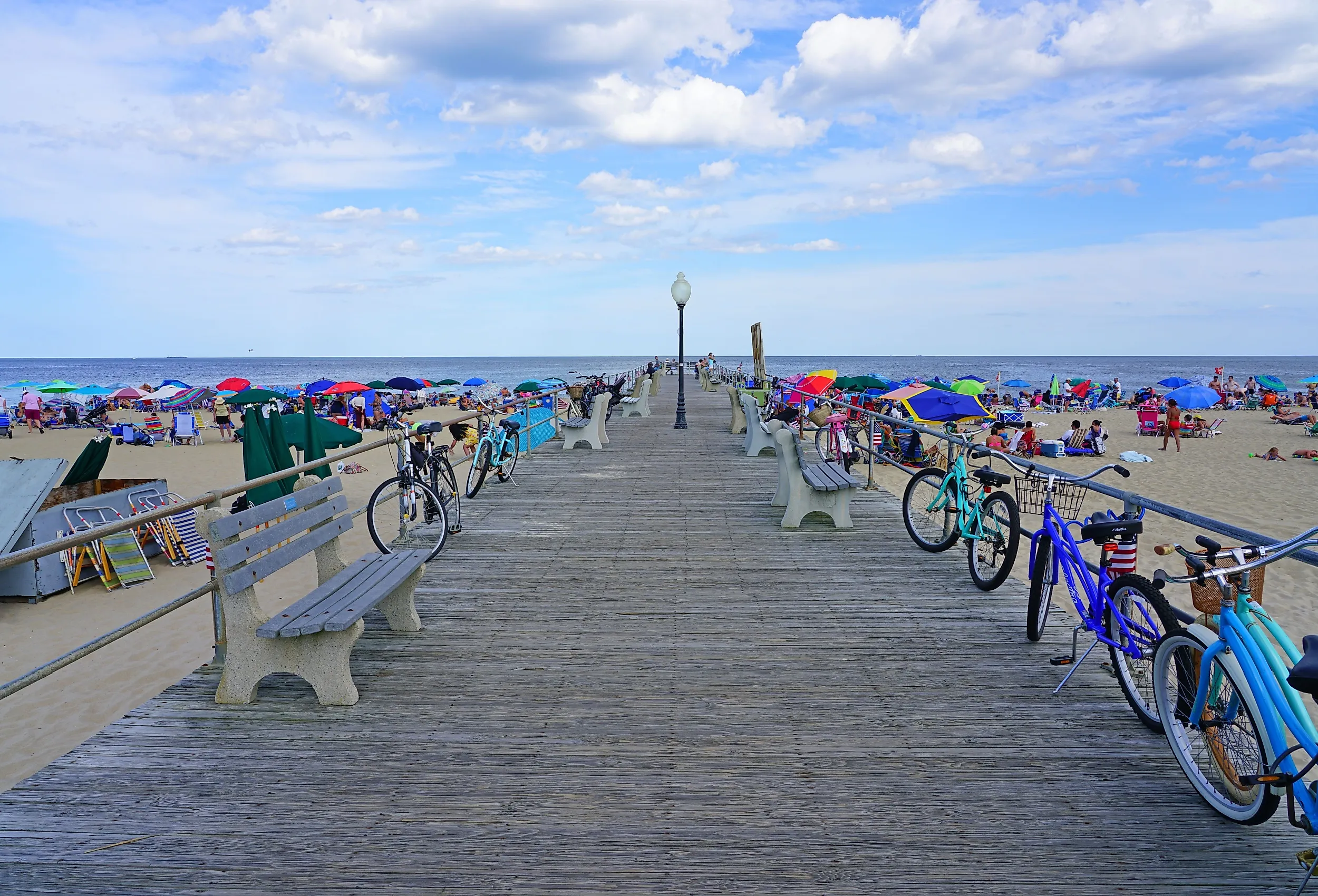 View of the boardwalk along the beach in Ocean Grove, a town on the New Jersey Shore, known for its historic Victorian houses. Editorial credit: EQRoy / Shutterstock.com