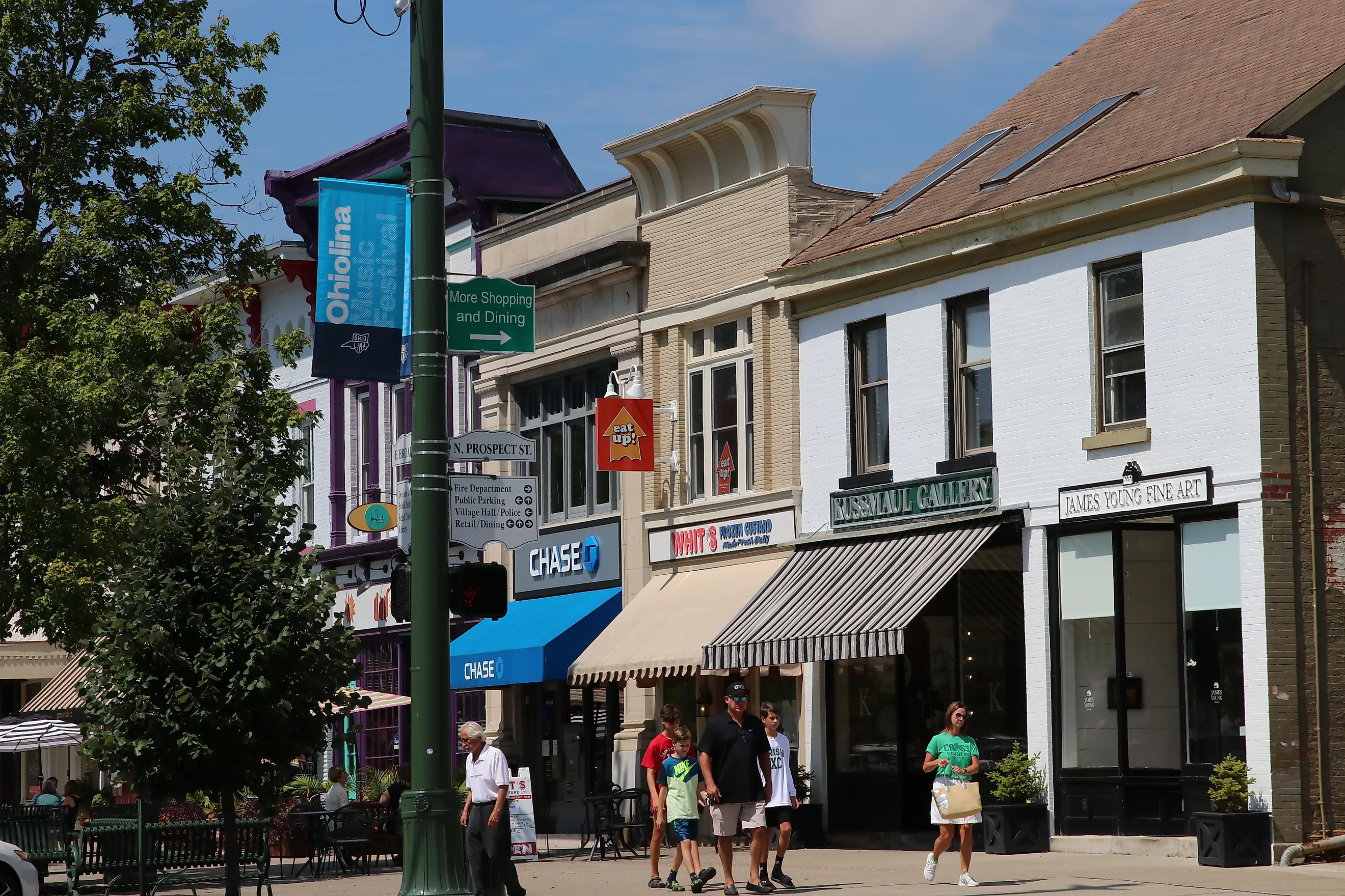 Shops, businesses, and dining establishments with sidewalk seating line the downtown block of Granville, Ohio. Editorial credit: Eric Glenn / Shutterstock.com