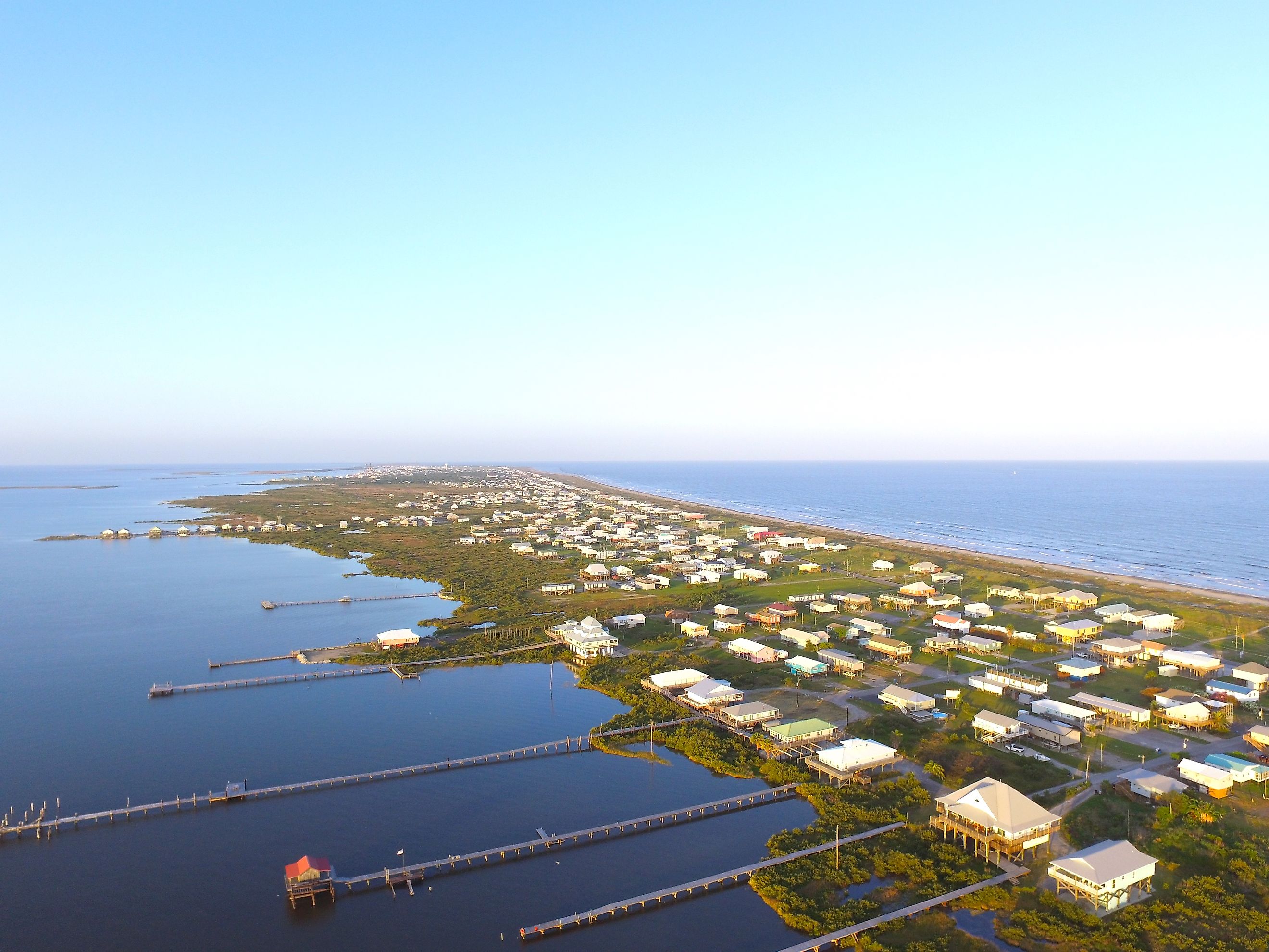 Stilt houses with long docks in the low-lying town of Grand Isle, Louisiana