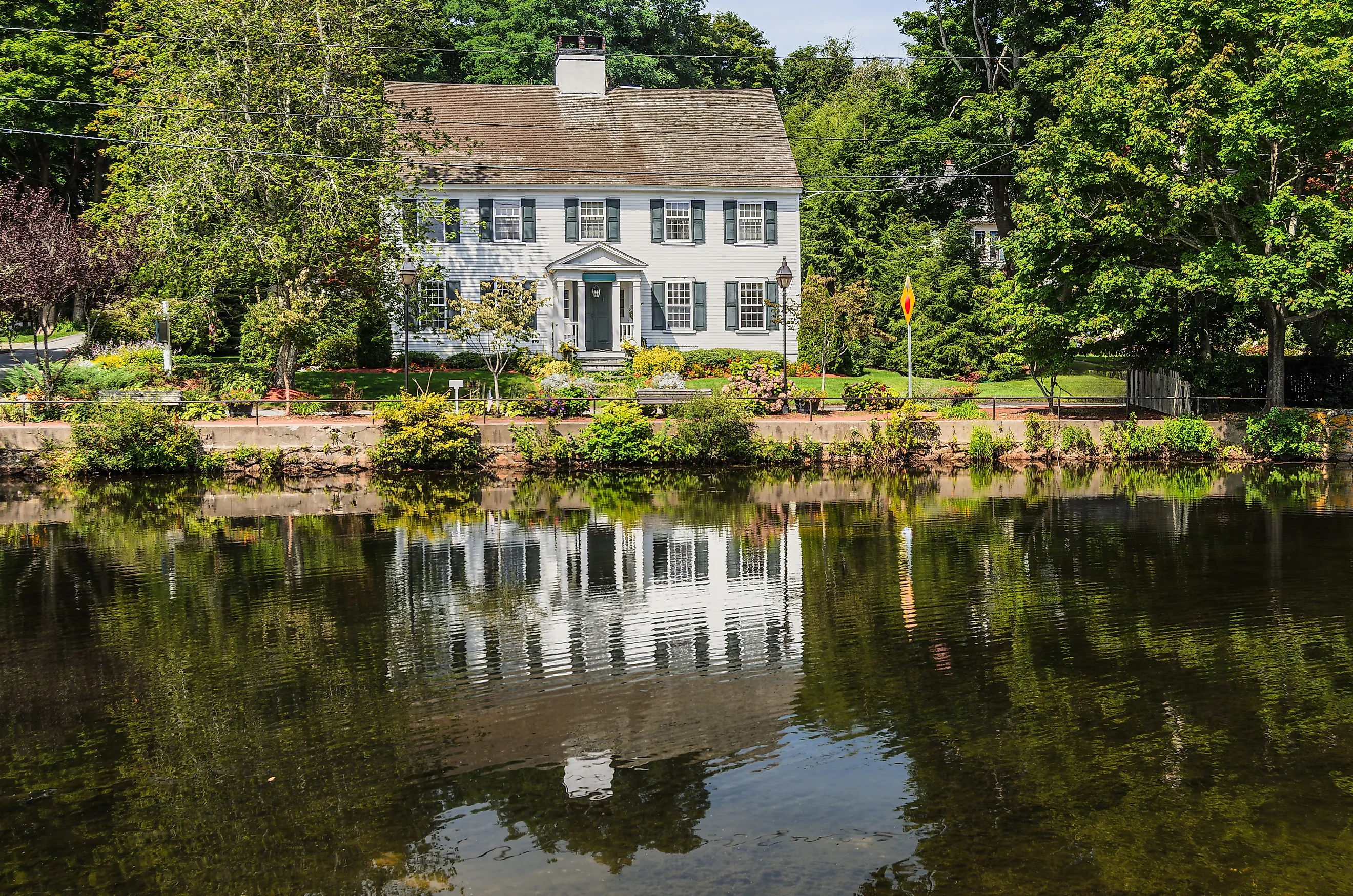 Historic New England house reflected in Shawme Lake, Sandwich, Massachusetts, USA