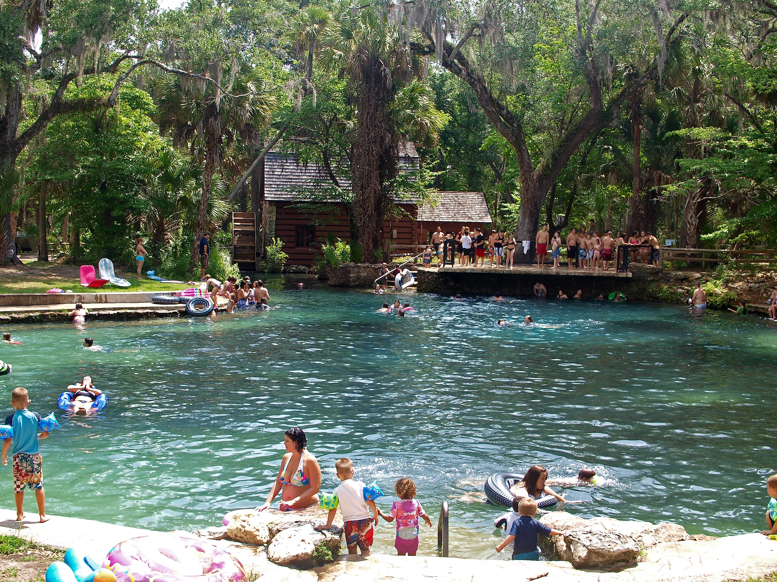 People enjoying in the spring fed pool of Juniper Springs Recreation Area. Image by Stillgravity via Shutterstock. 