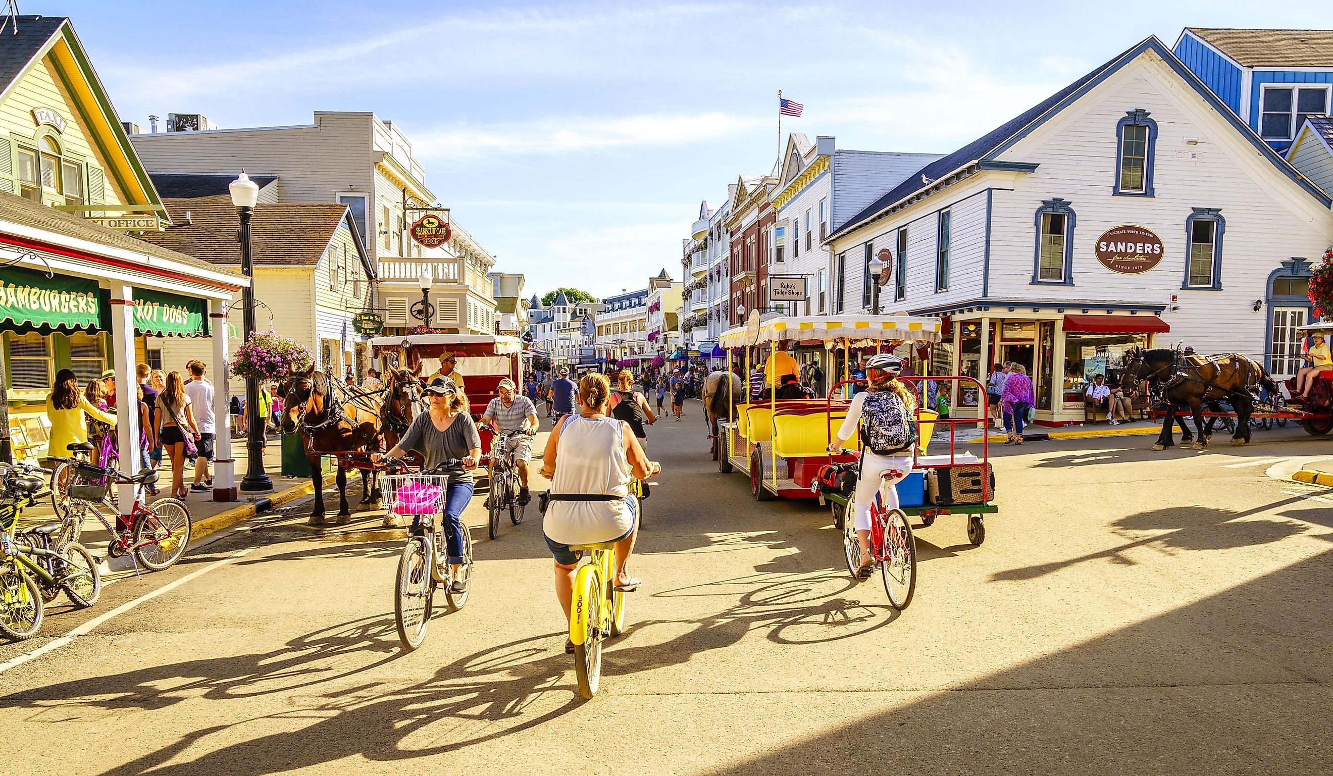 Vacationers take on Market Street on Mackinac Island that is lined with shops and restaurants. Editorial credit: Alexey Stiop / Shutterstock.com
