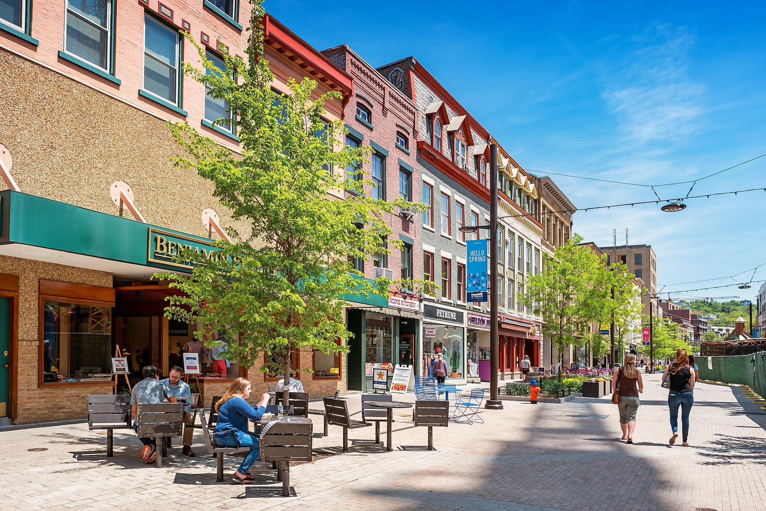 People have lunch and walk in a pedestrian area of downtown Ithaca, New York State