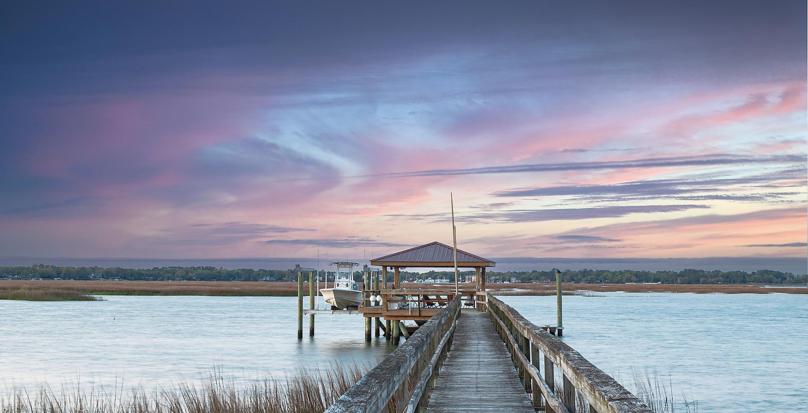View from the dock of a boathouse with a pink sky in Beaufort, South Carolina.