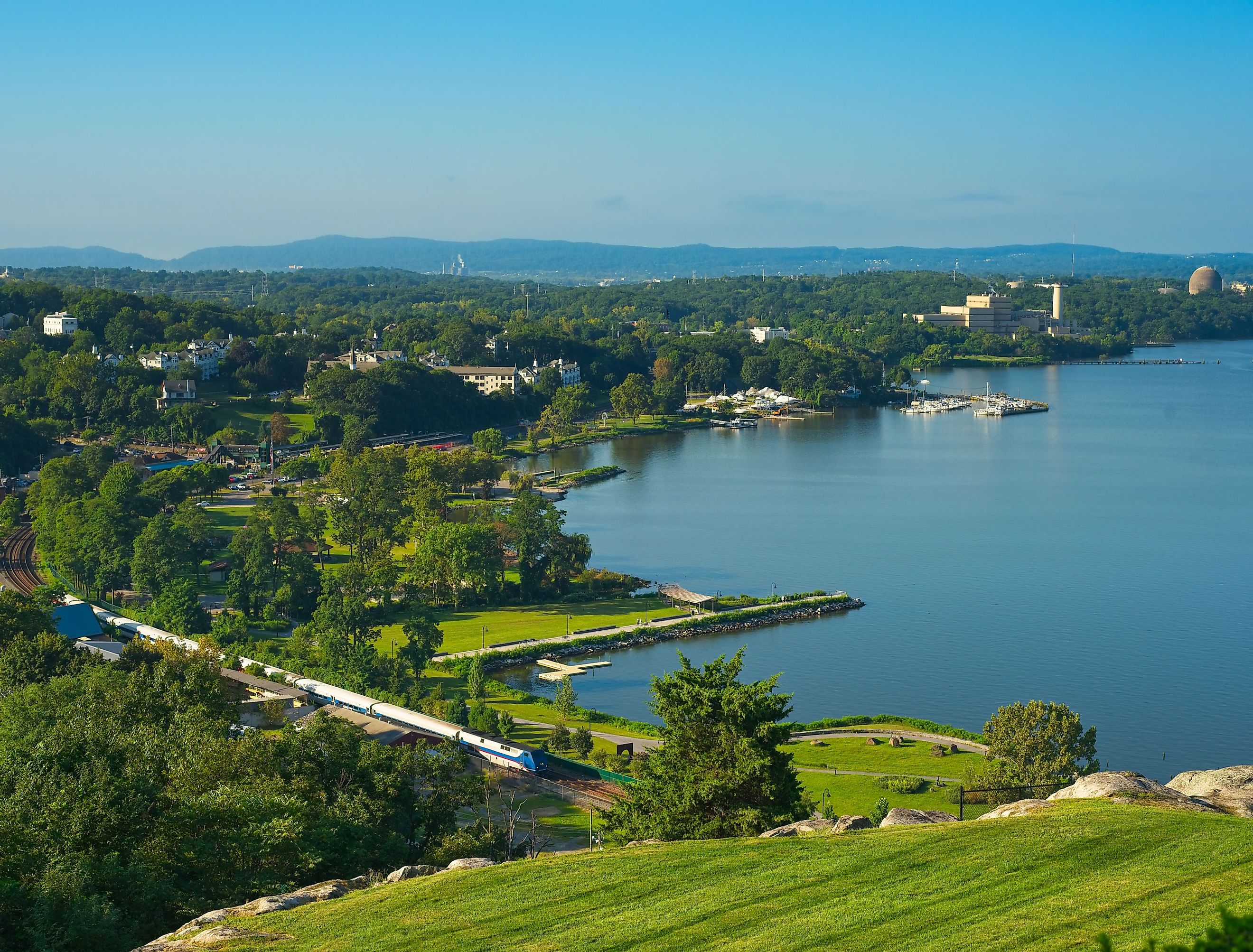 A passenger train heads north from Peekskill, New York, on the Hudson River. Image credit Kenneth Sponsler via shutterstock