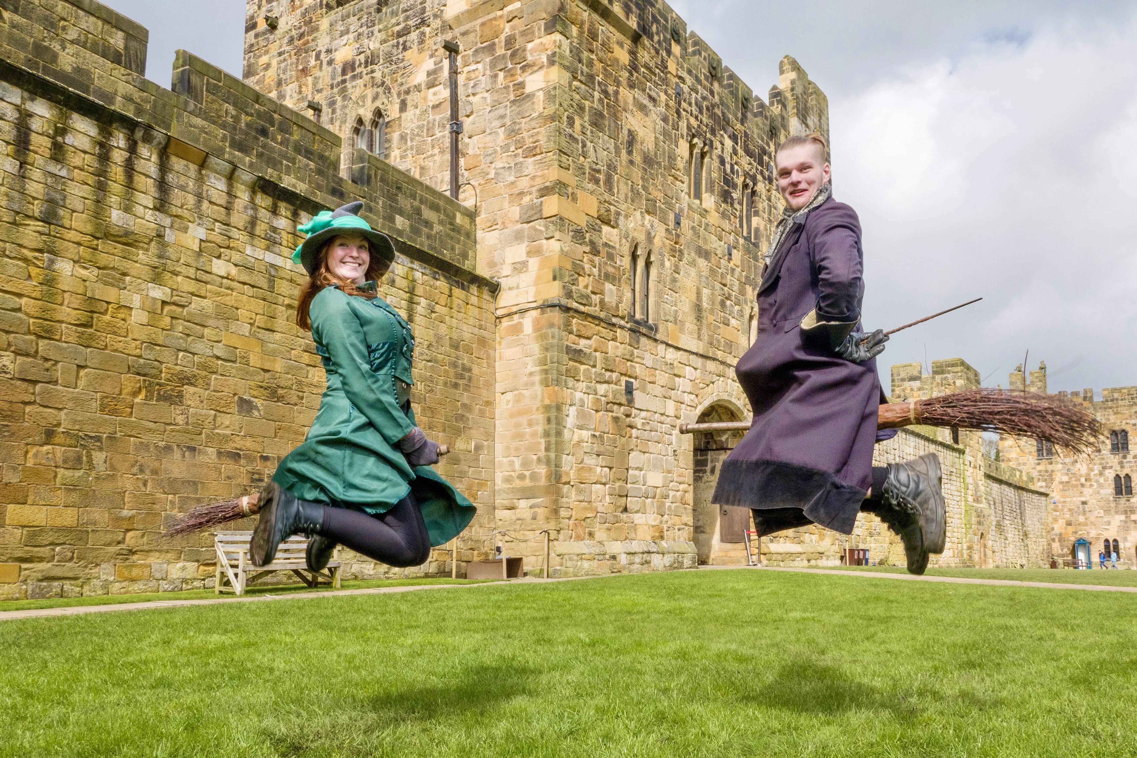 Two participants learn how to ride a broom and play quidditch at the Alnwick Castle. Credit: Bryan Dearsley