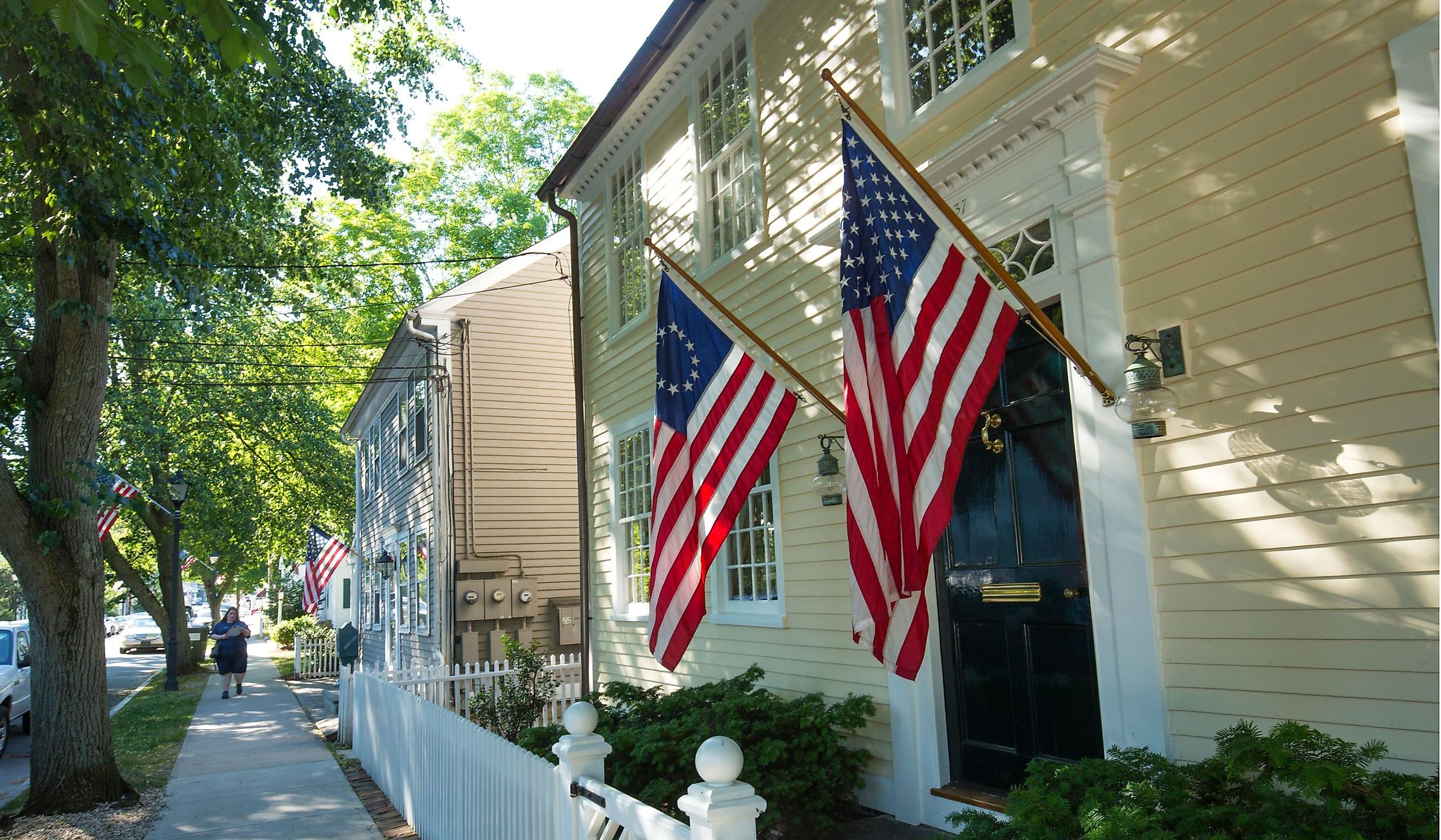 American flags and a white picket fence line Main Street in Essex, Ct. Editorial credit: Jeff Holcombe / Shutterstock.com