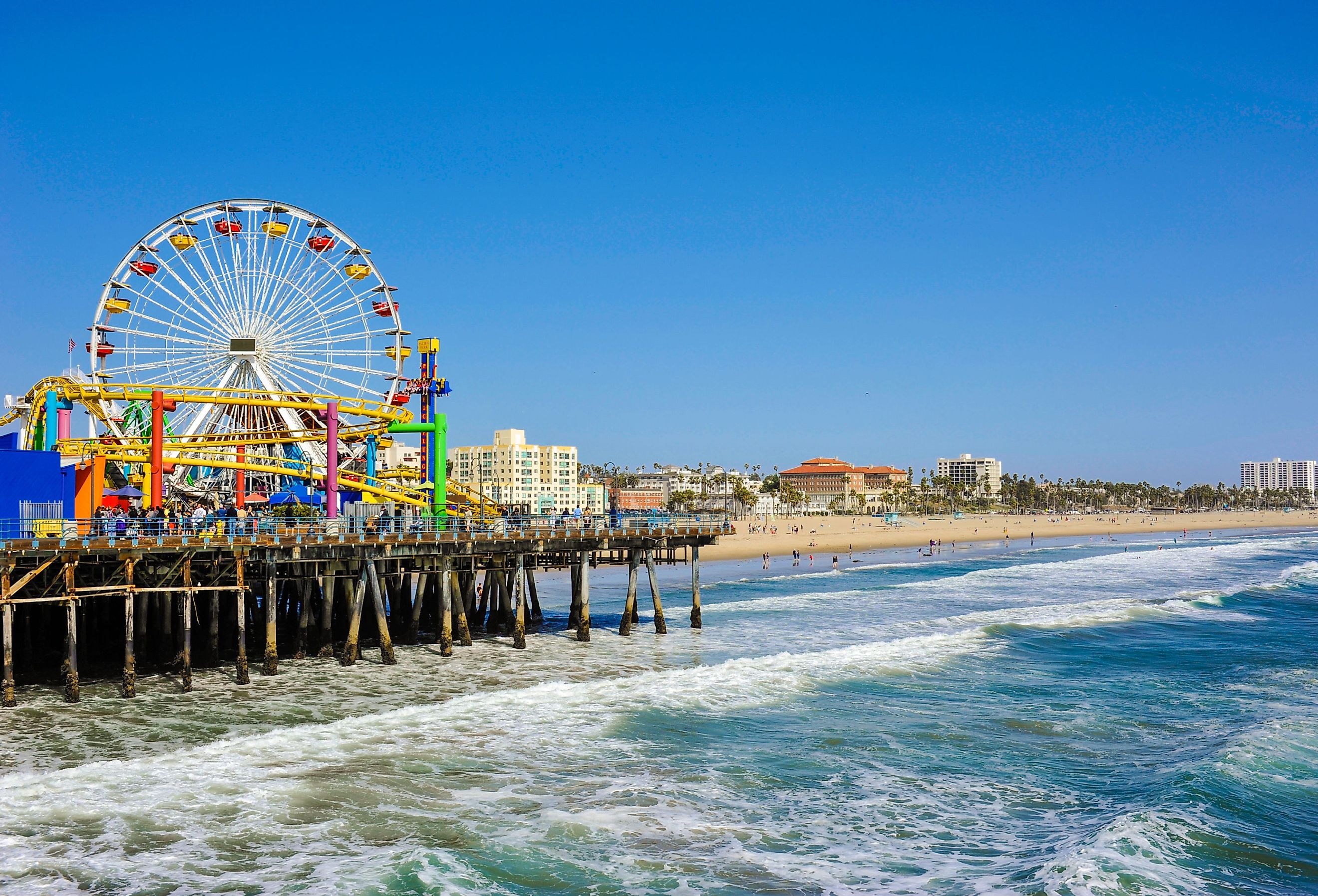 View of the Santa Monica pier in California, which features an amusement park and beach. Image credit Mark and Anna Photography via Shutterstock.