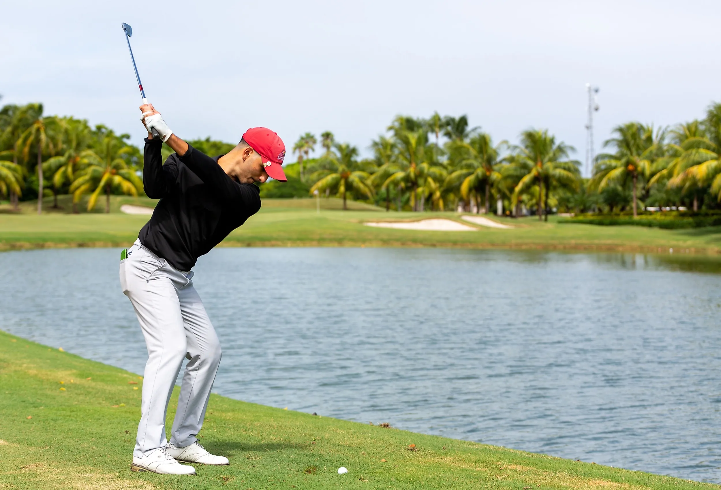 Golfer teeing off a the Trump National Doral. Editorial credit: YES Market Media / Shutterstock.com