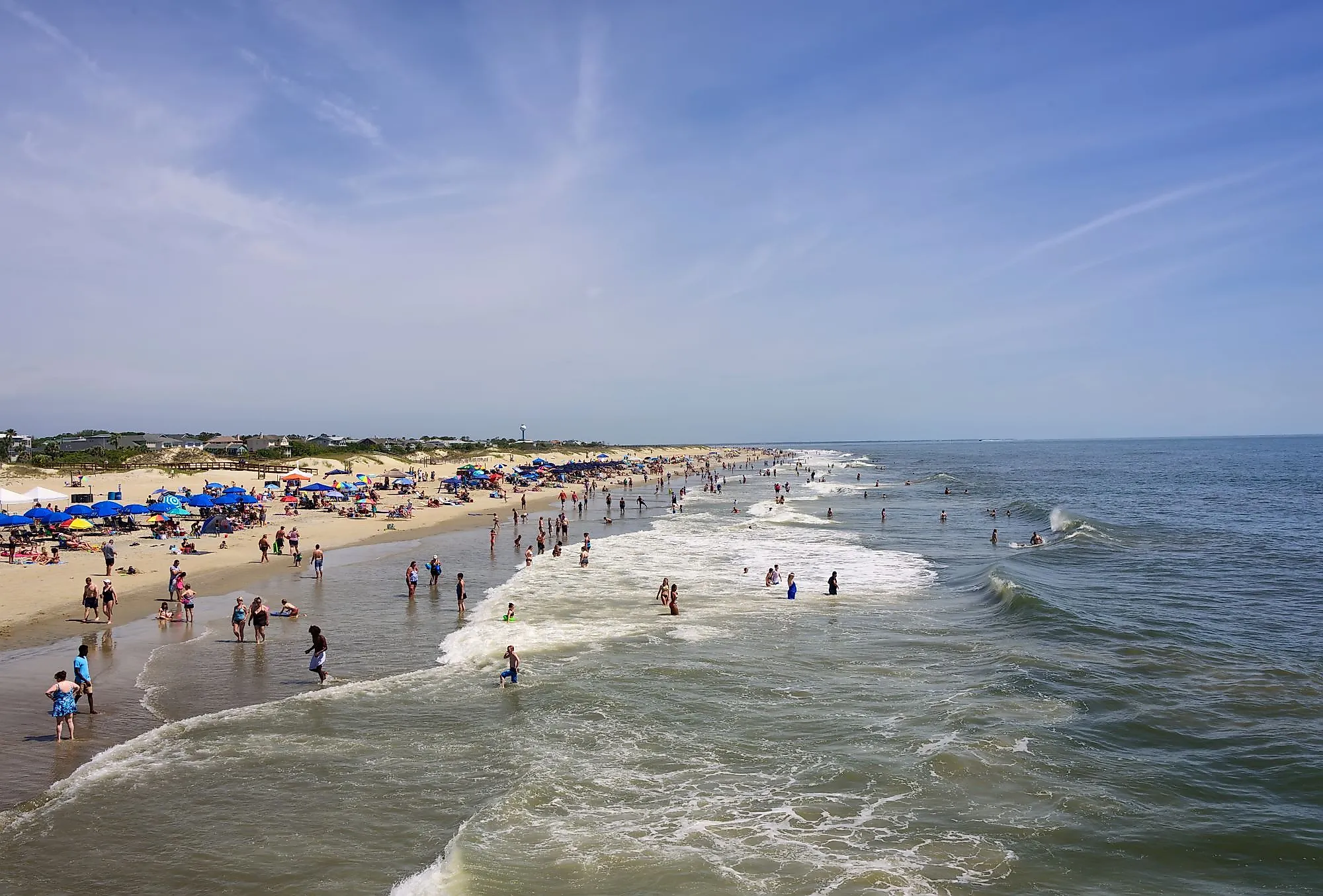 People enjoying a day at the beach on the Atlantic Ocean in Tybee Island, Georgia. Editorial credit: Ruth Peterkin / Shutterstock.com