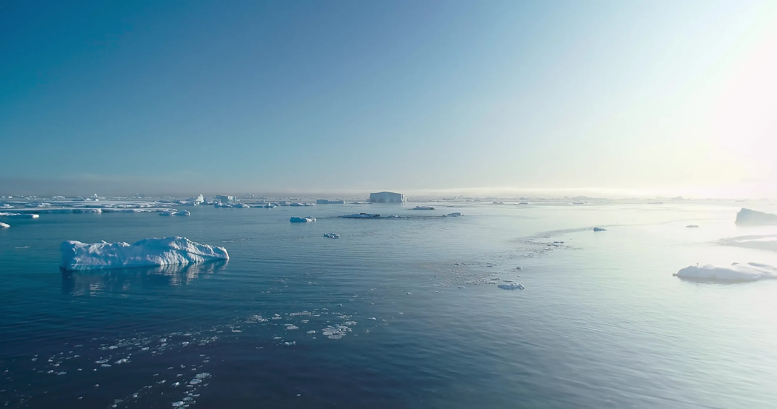 Sunny Antarctica ocean aerial landscape, showcasing ice actively melting. 