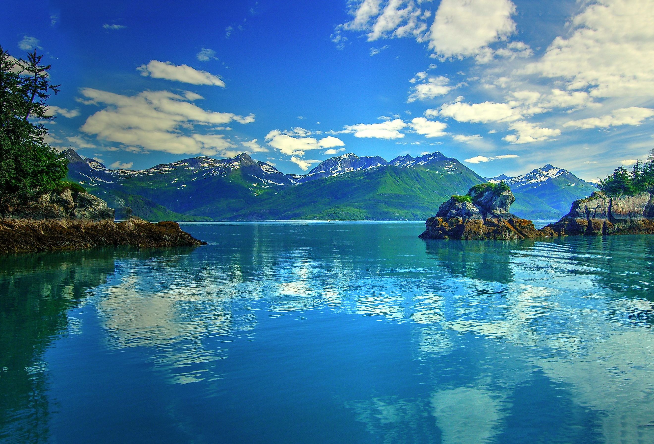 Prince William Sound, Valdez, Alaska. Reflection of clouds in the water with mountains in the background. Image credit Krishna.Wu via Shutterstock.
