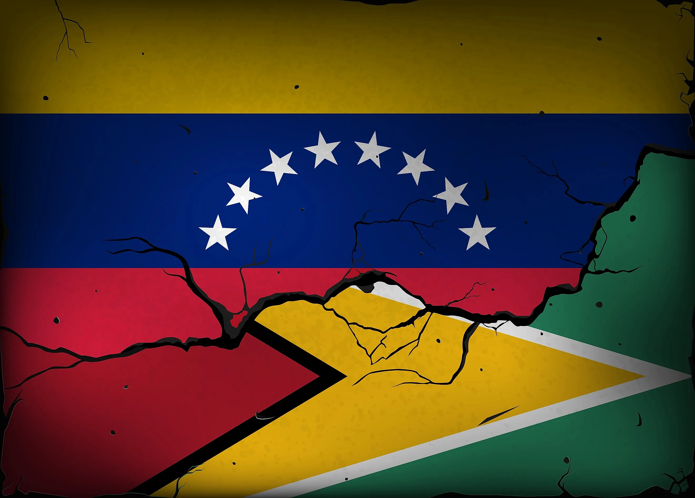 Flags of Venezuela and Guyana against a background of a wall with cracks. (Credit: Evgeny Simonov via Shutterstock)