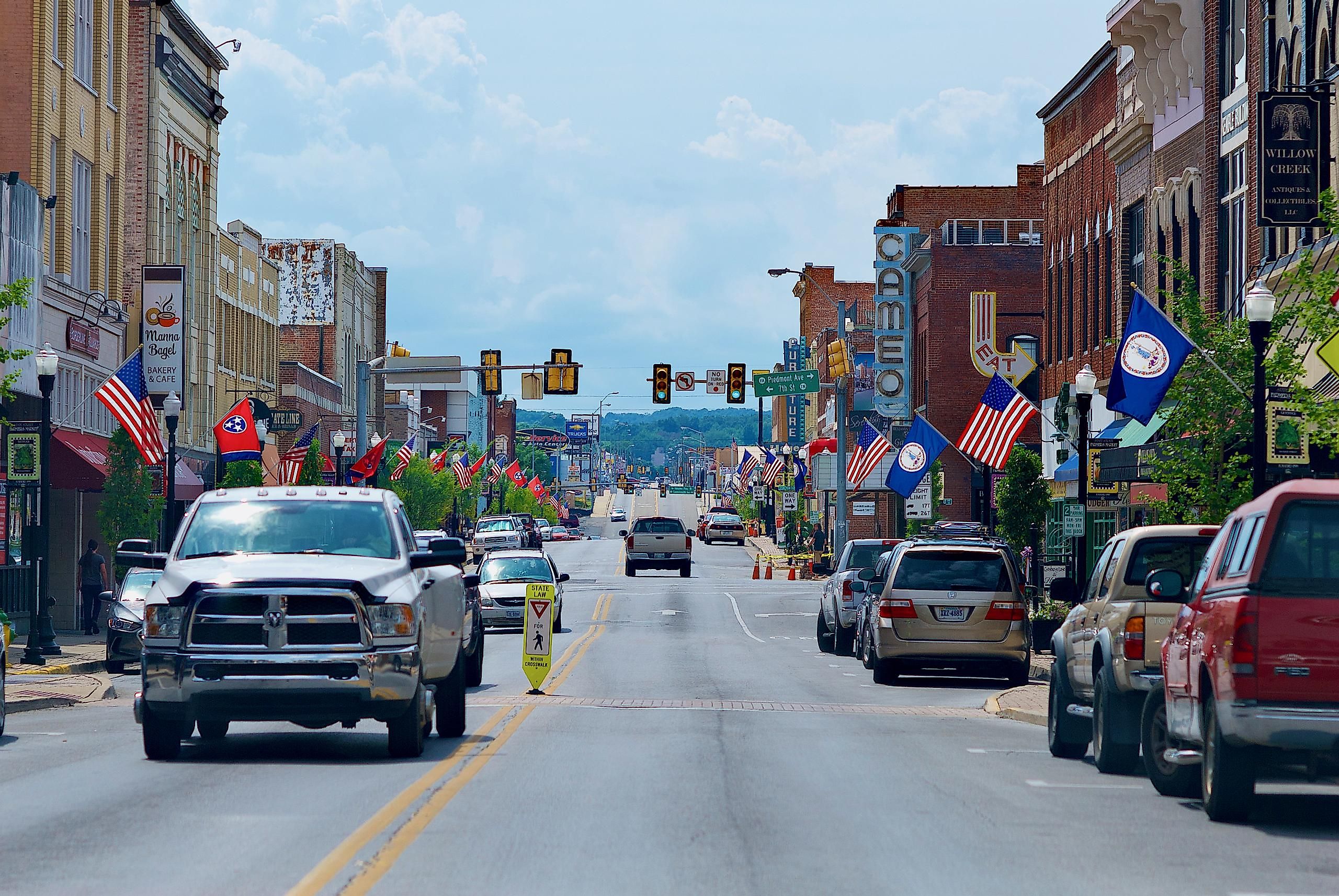 A pickup truck travels toward the camera on the Tennessee side of State Street in the separated cities of Bristol, Tennessee (l), and Bristol, Virginia (r).