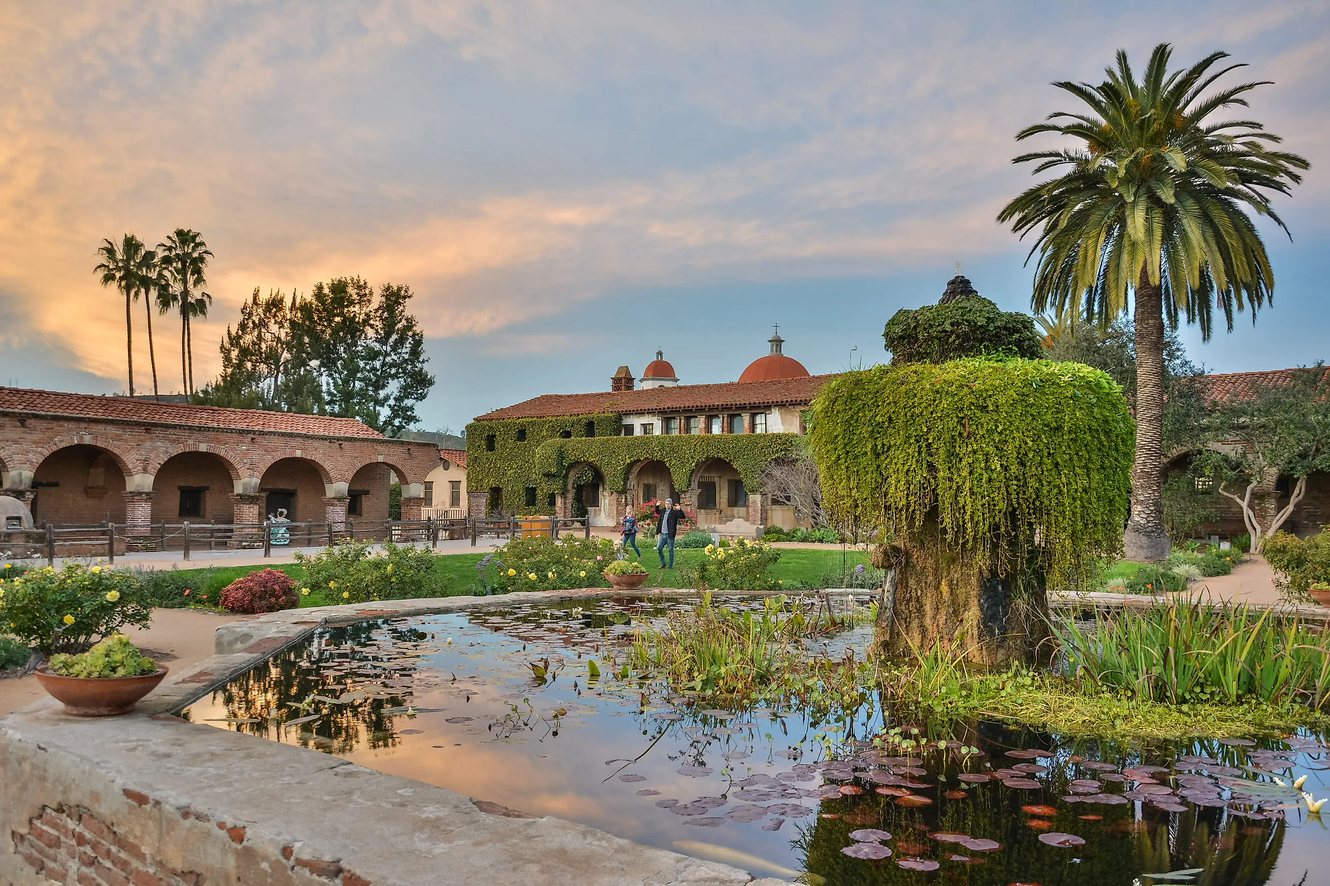 Courtyard of Mission San Juan Capistrano in California at dusk.